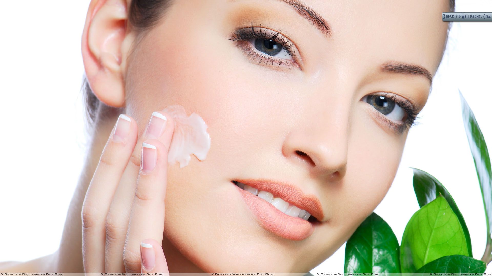 Female Model Applying Cream On Her Face Wallpaper