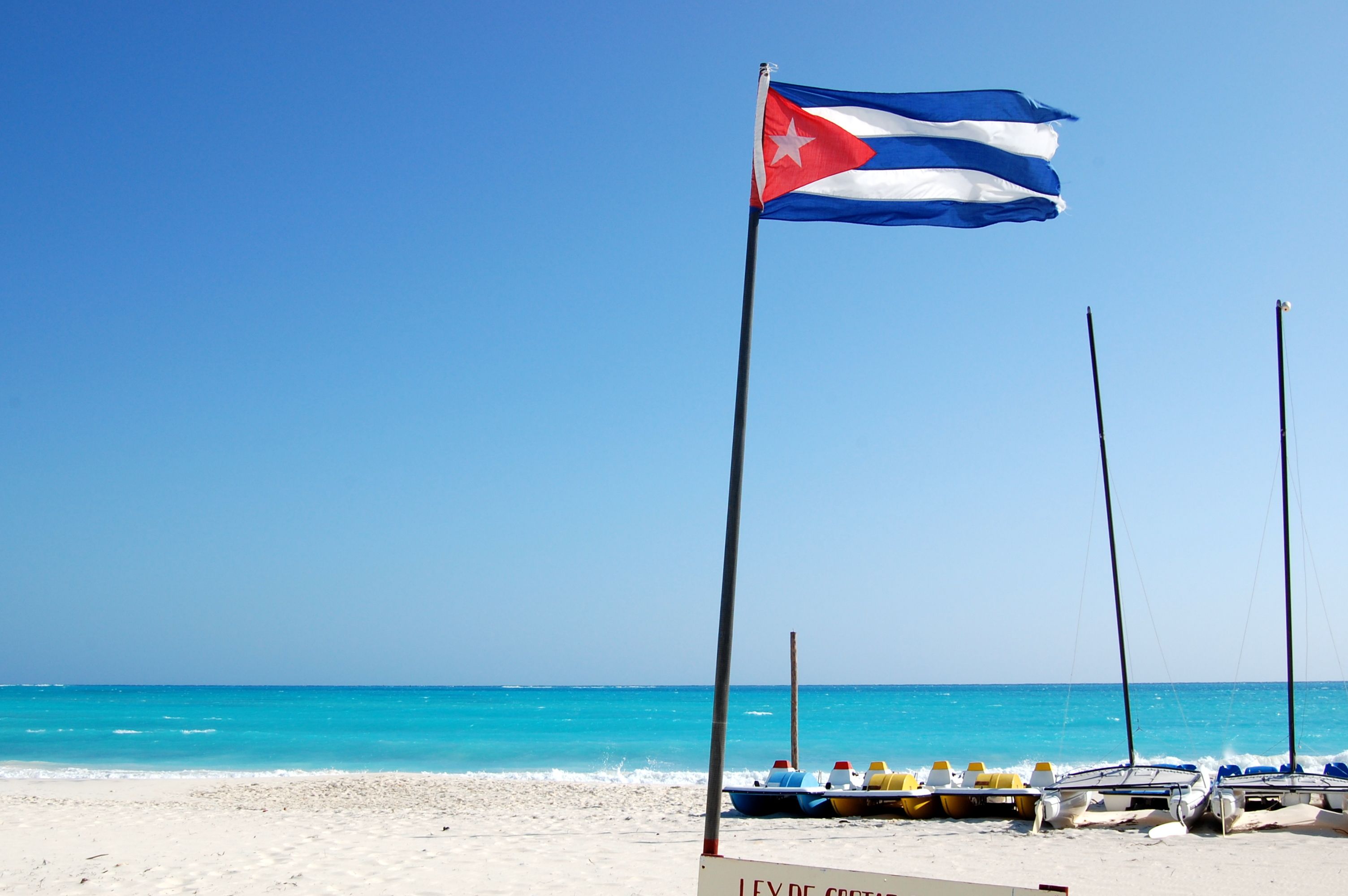 Flag of Cuba on the beach in the resort of Cayo Largo, Cuba
