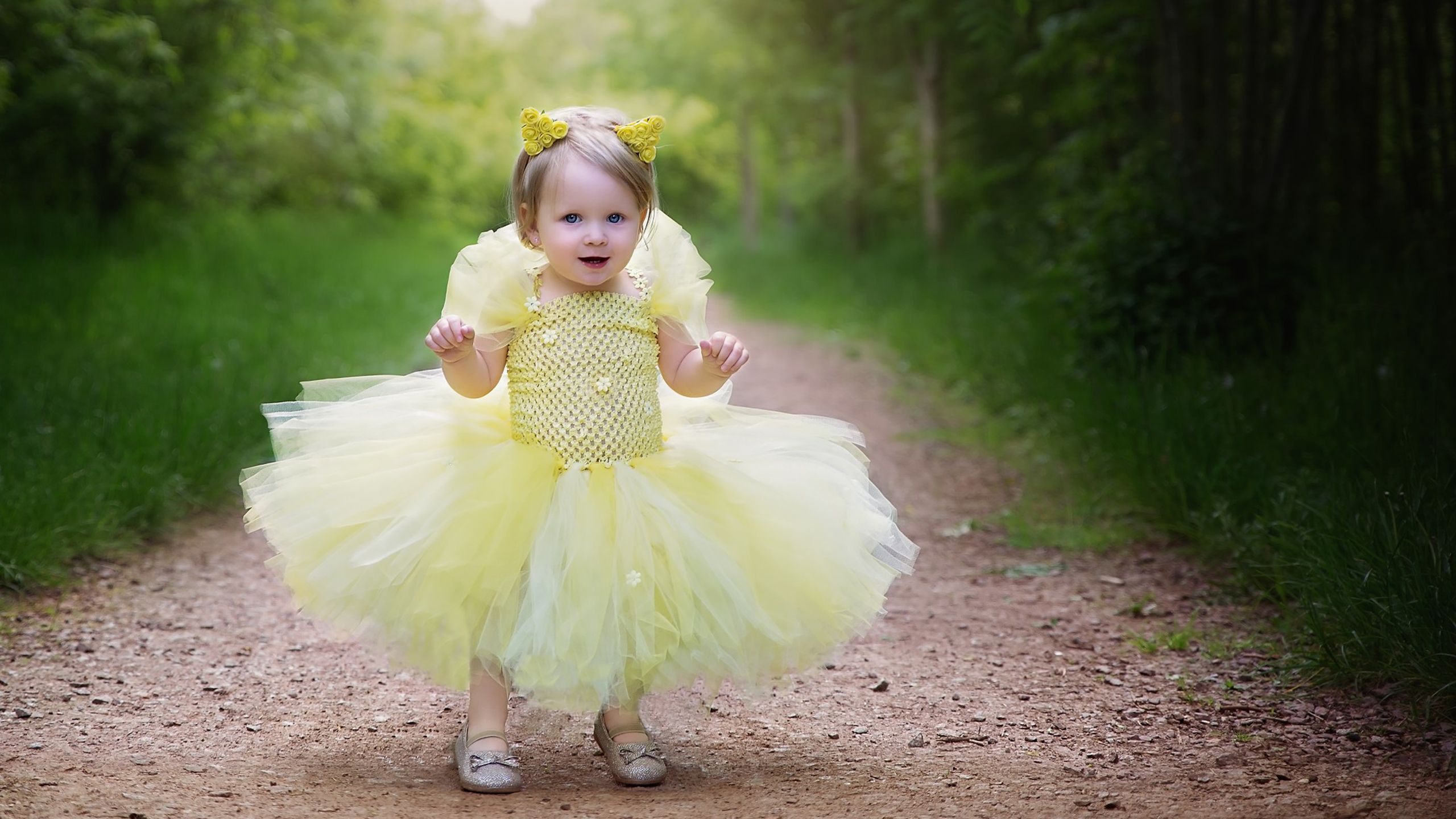 cute baby girl is wearing yellow dress standing on road in green trees background HD cute Wallpaper