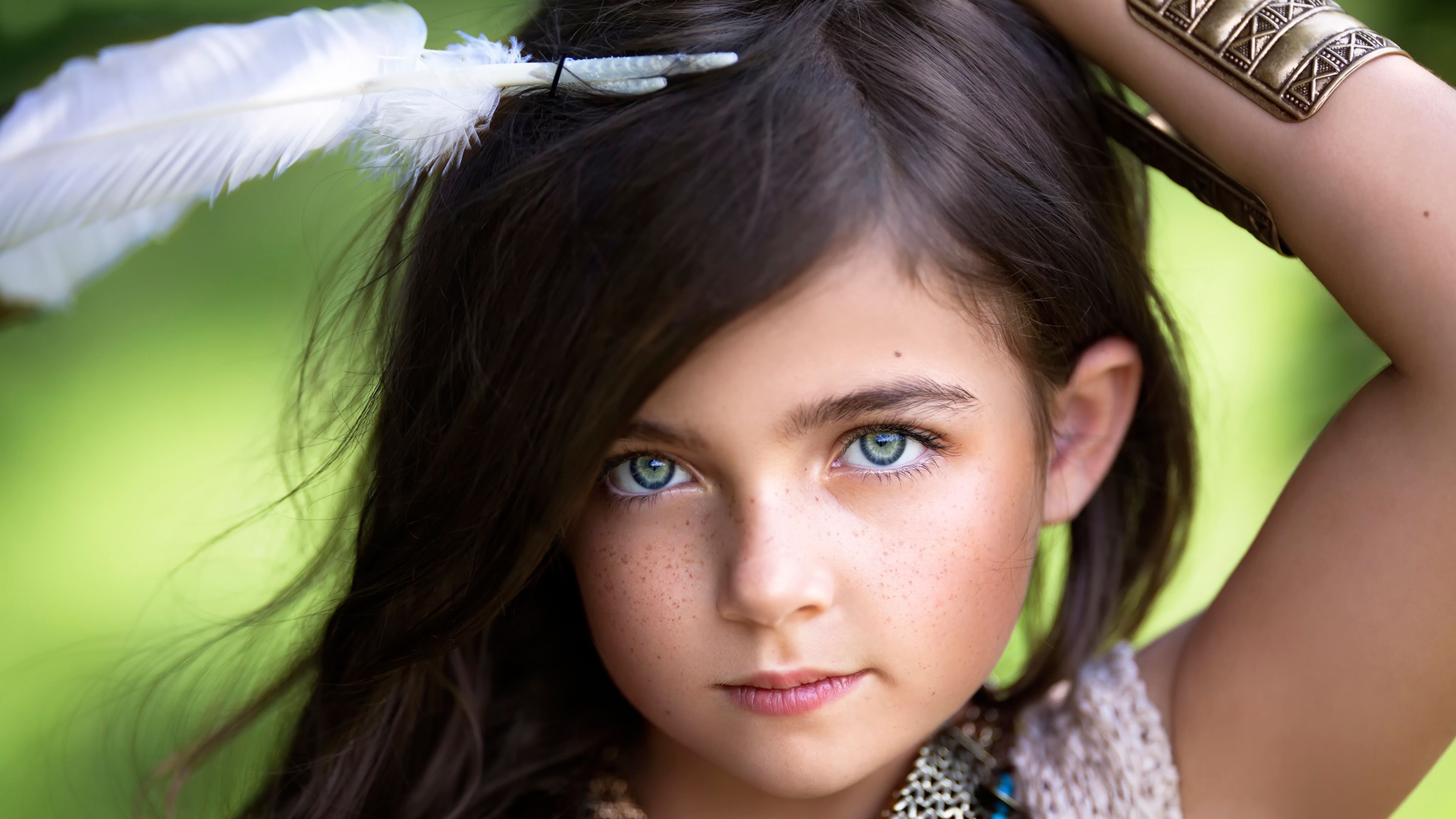 Little beautiful girl with a white feather in her hair Desktop wallpaper 2560x1600