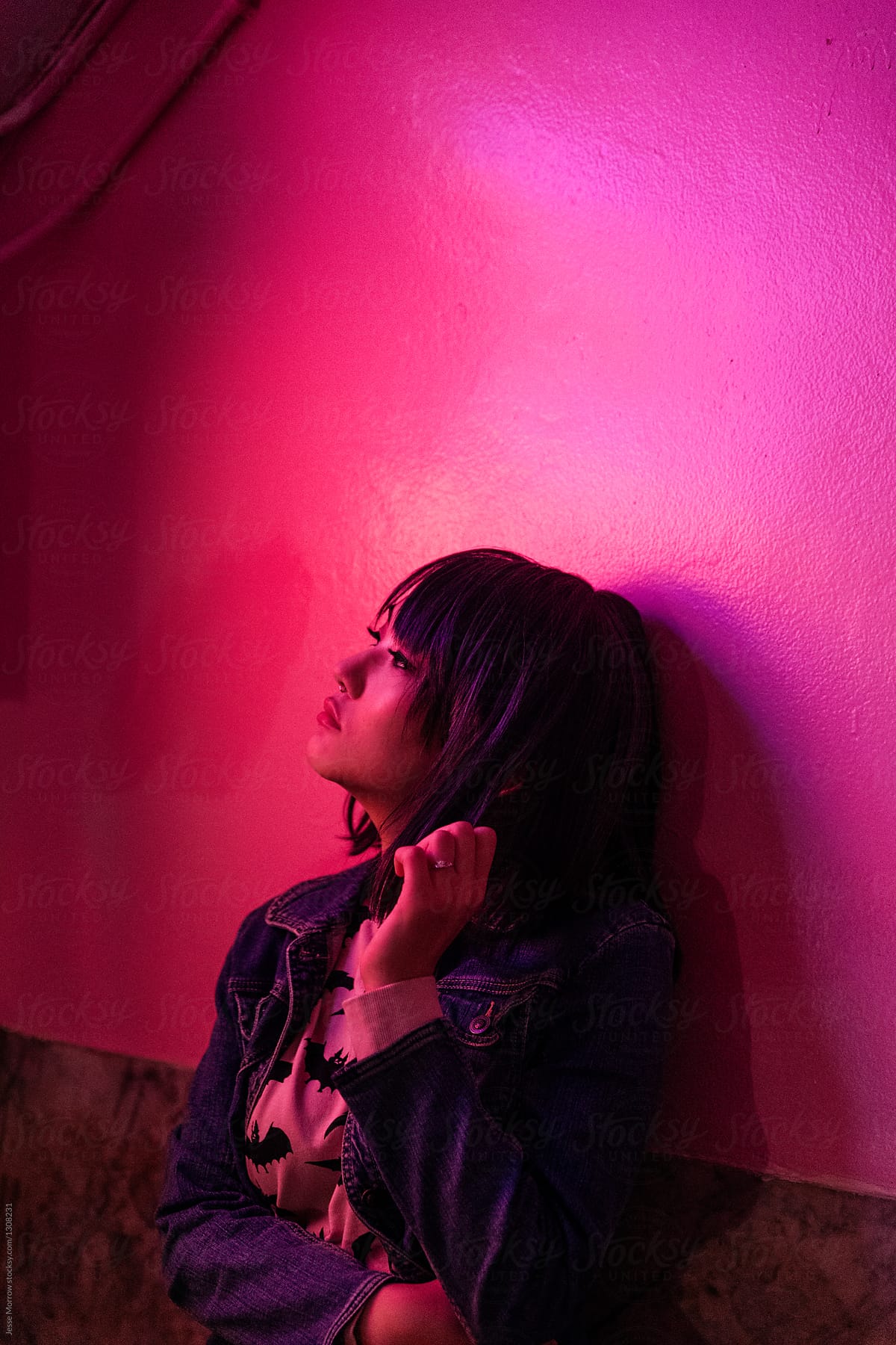 Portrait of young asian female woman in pink room with neon lights