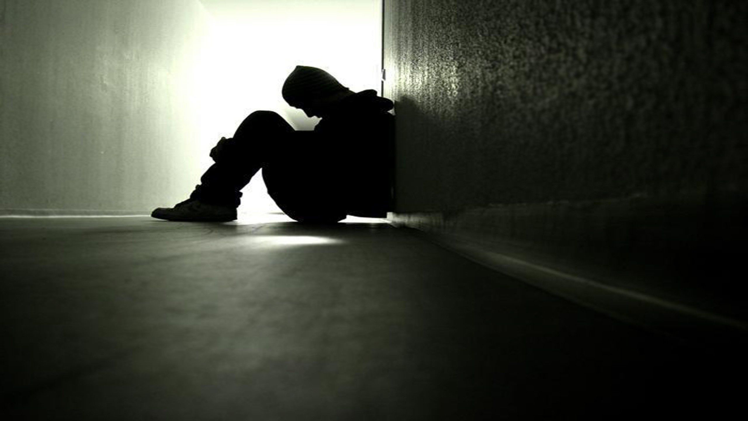 Sad boy sitting alone in dark wallpaper hd