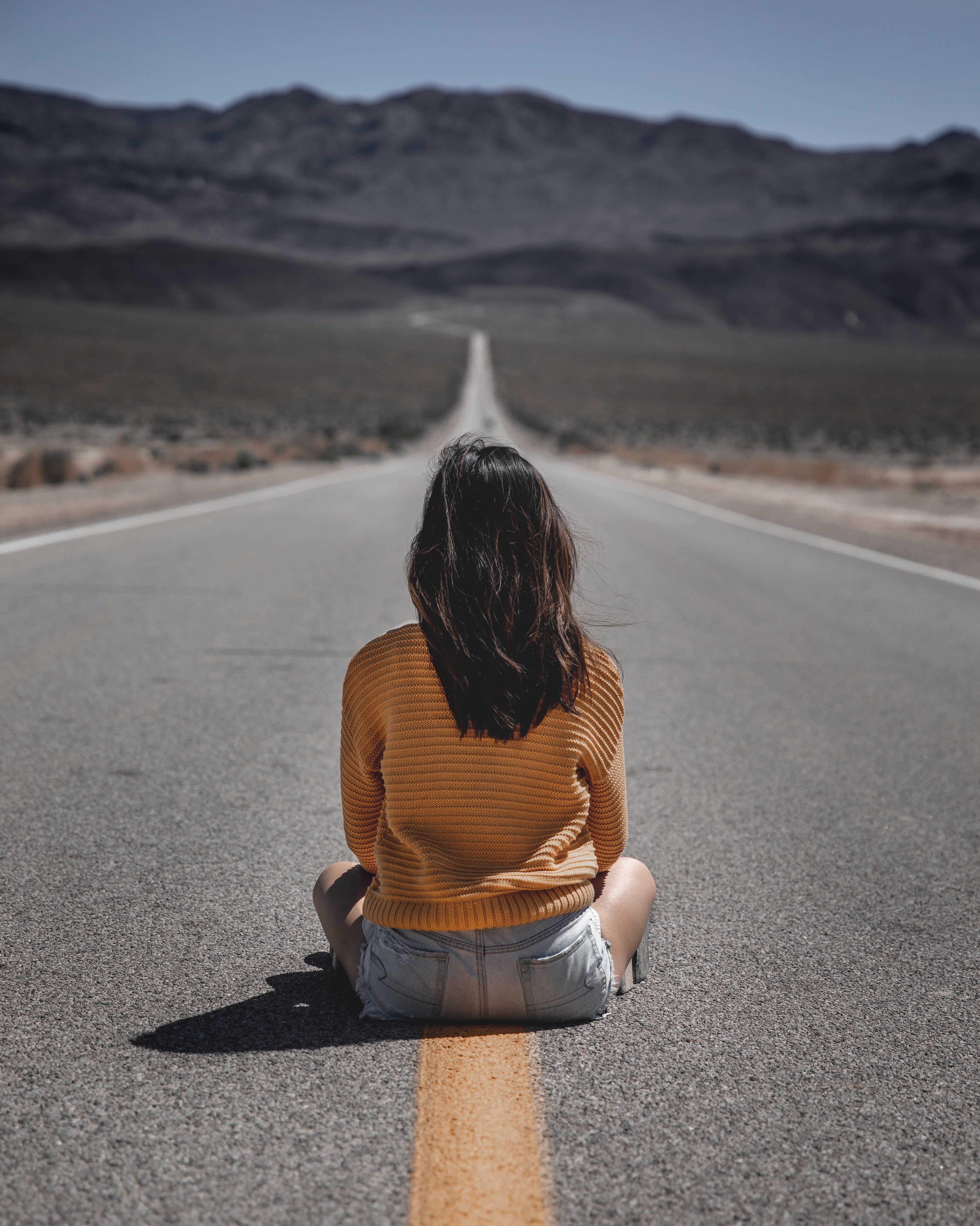 woman sitting on the road photo