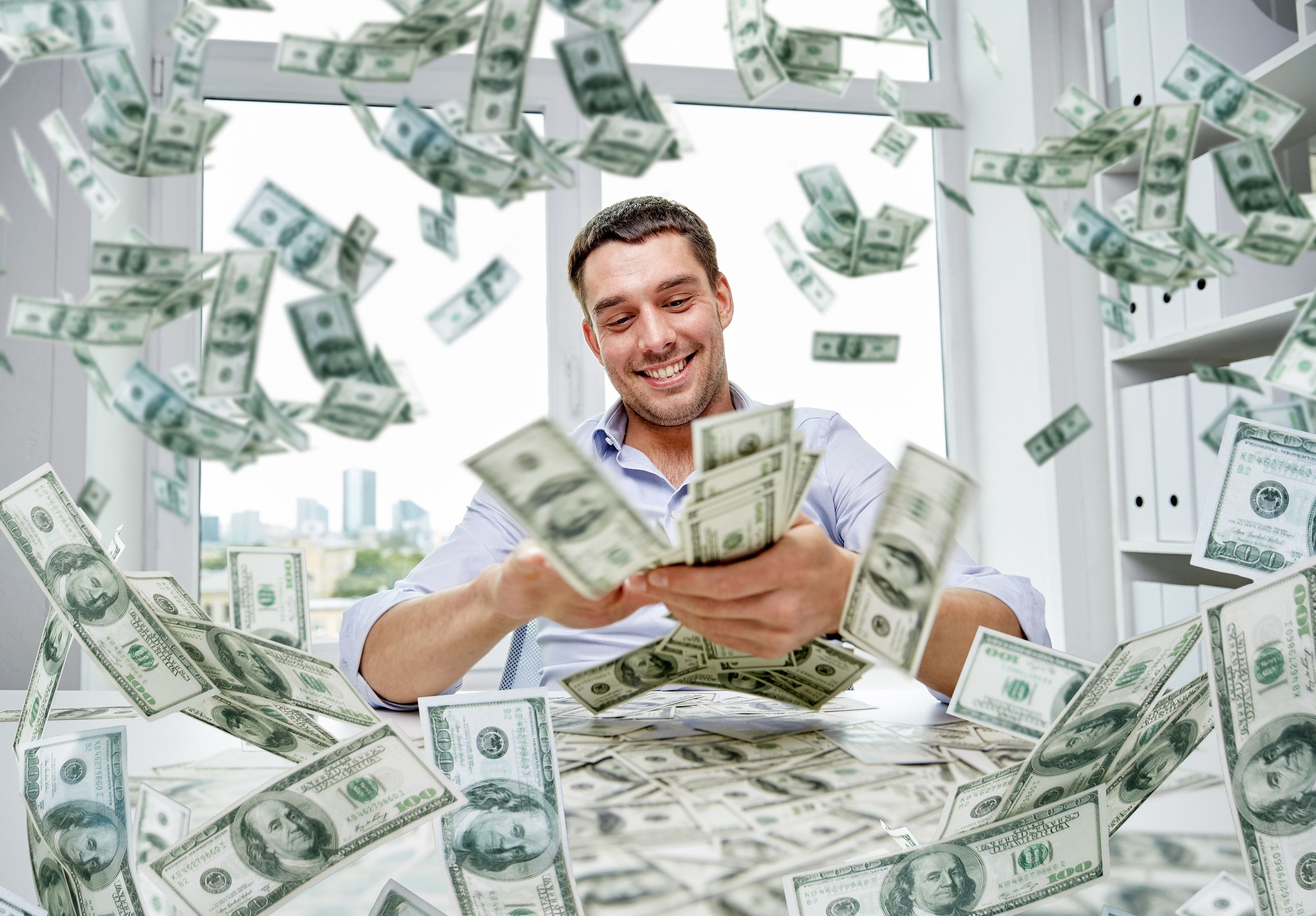 A smiling man is scattering dollars .zastavki.com