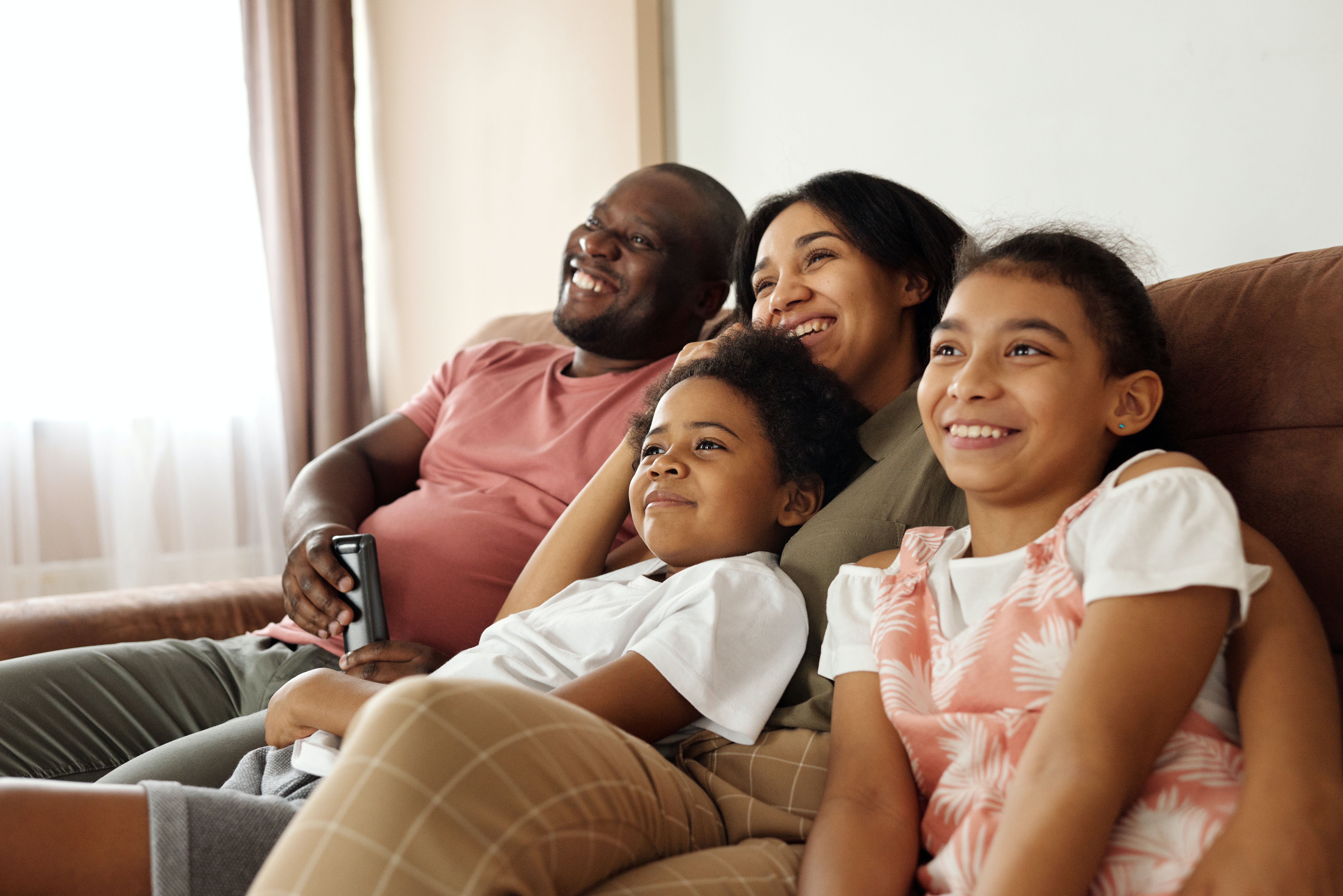Happy Family Sitting on a Couch and .pexels.com