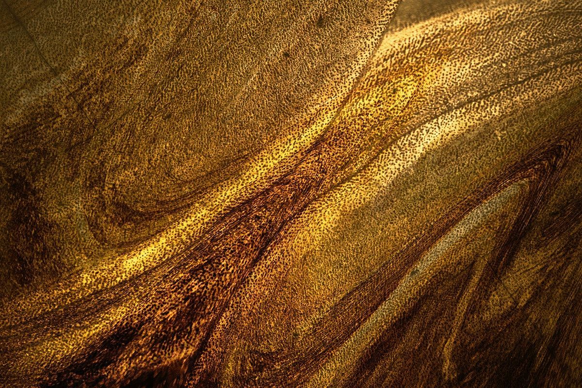 Dark gold paint textured background .com