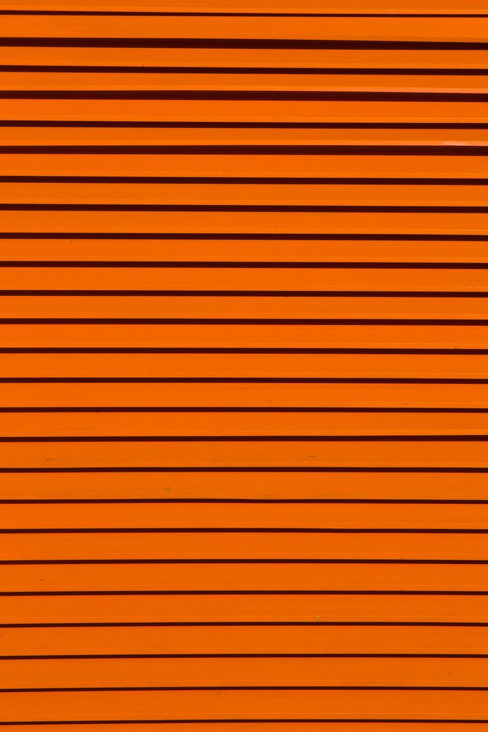 minimalist photography of orange wall .com
