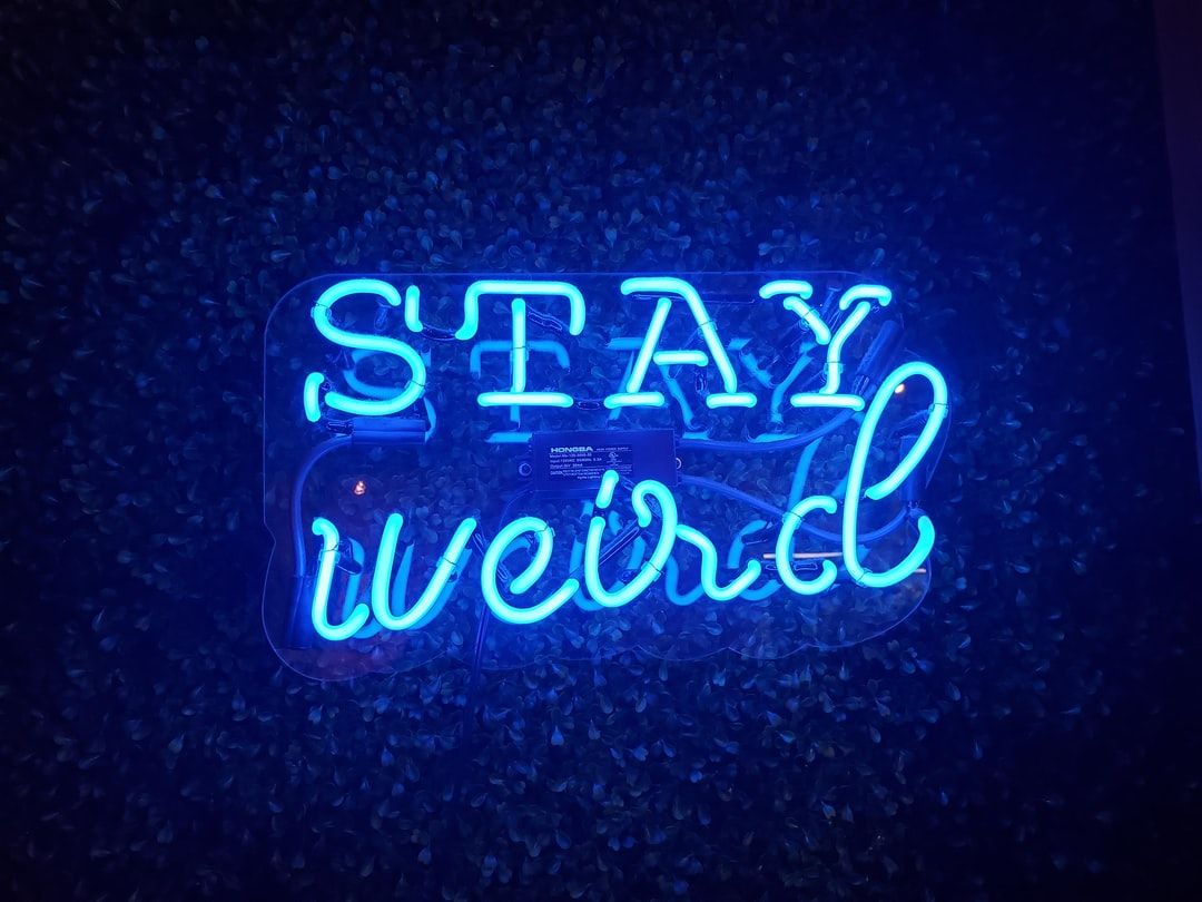 blue Stay Weird neon light signage .com
