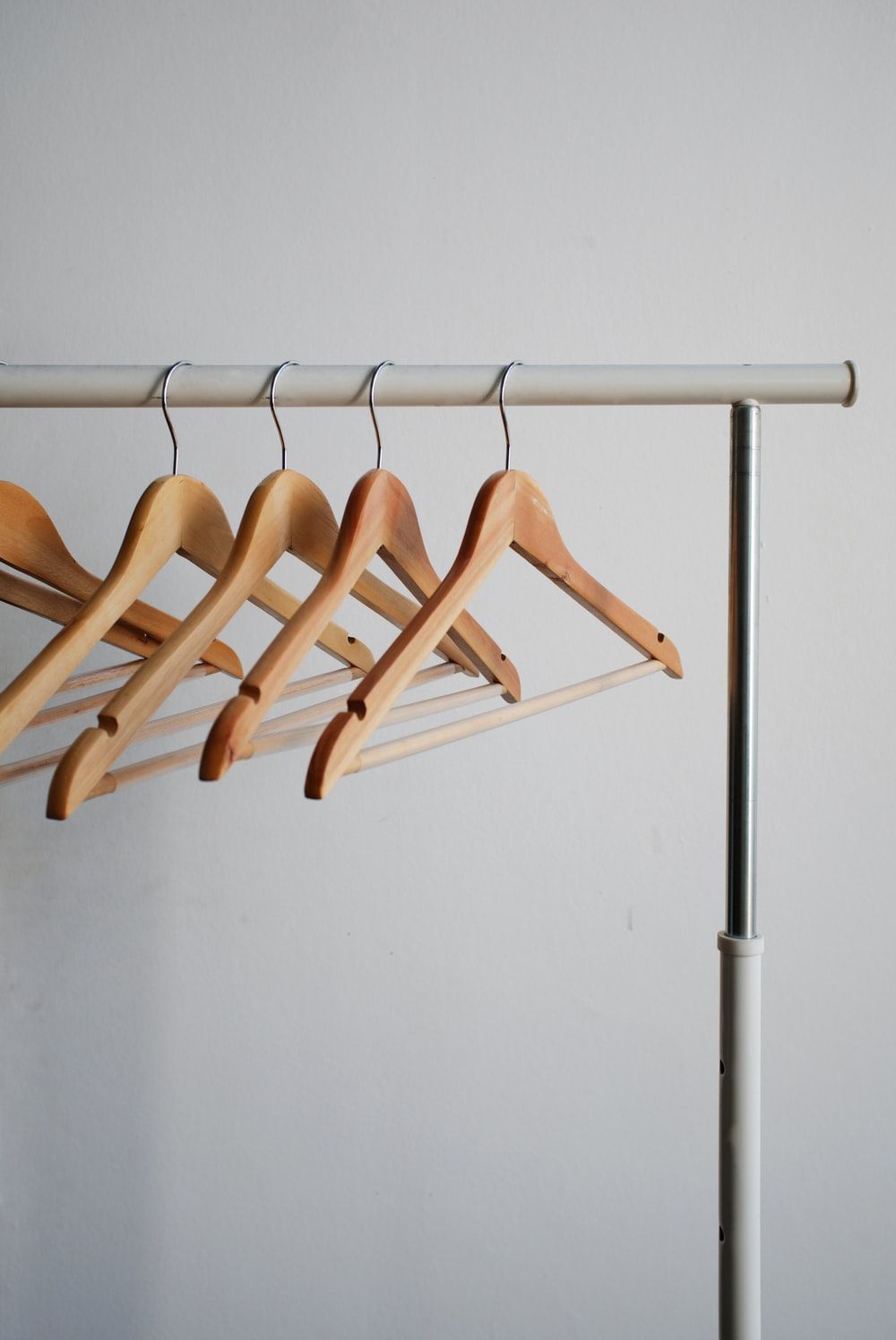 four brown wooden clothes hangers photo .com