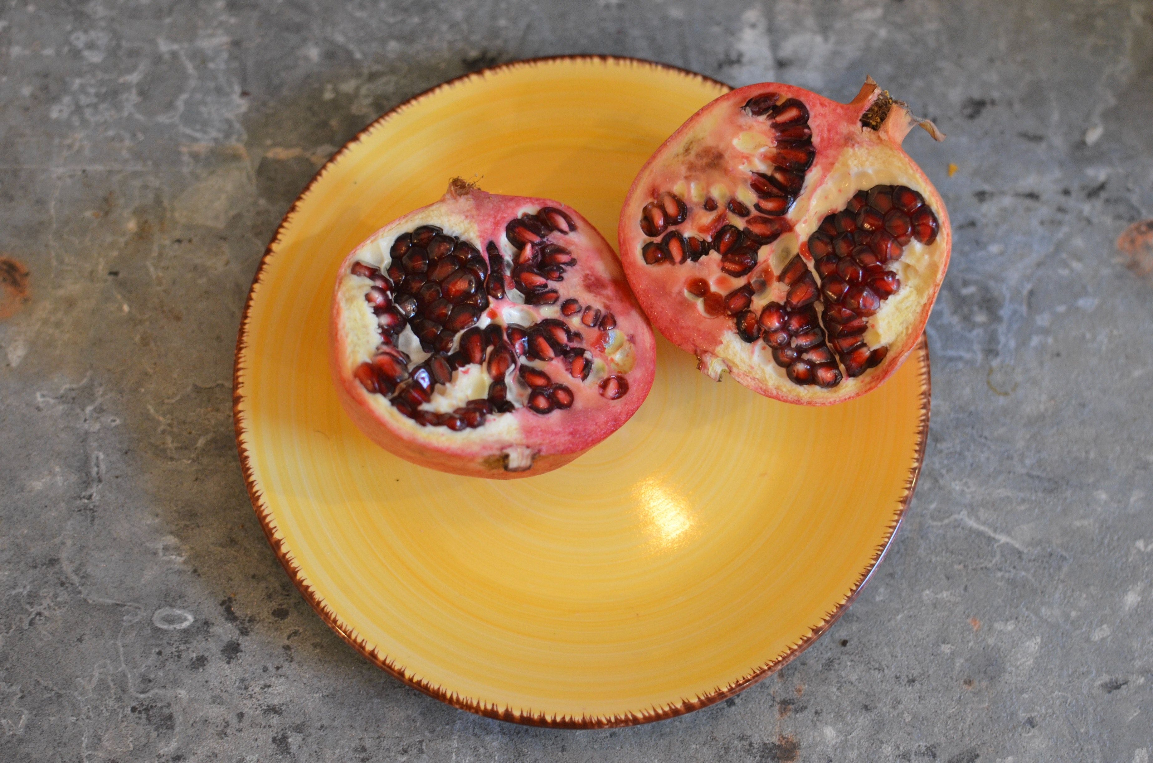Sliced Pomegranate Fruit on Yellow Plate · Free