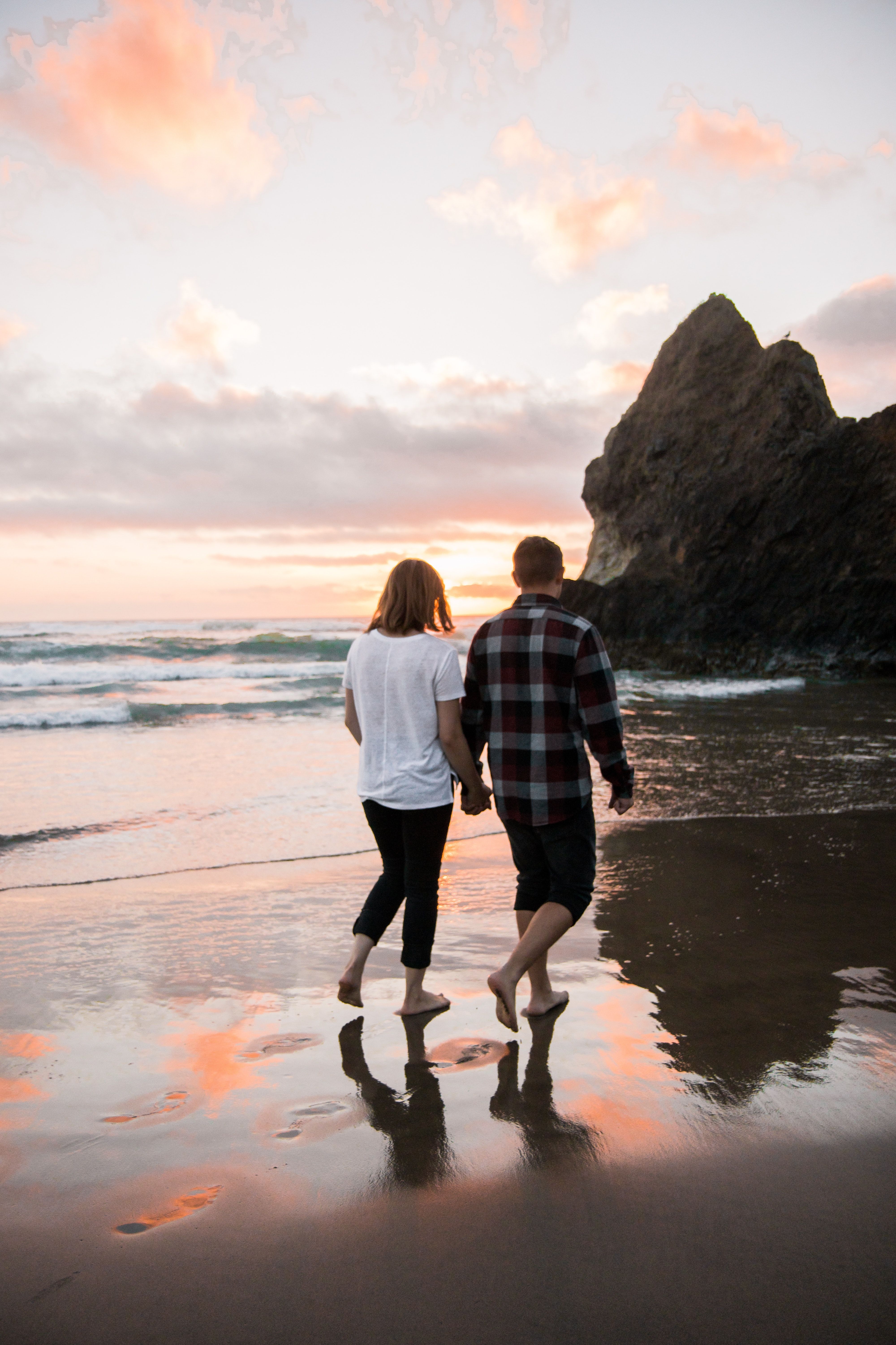 Couple Walking on Beach While Holding Hands · Free