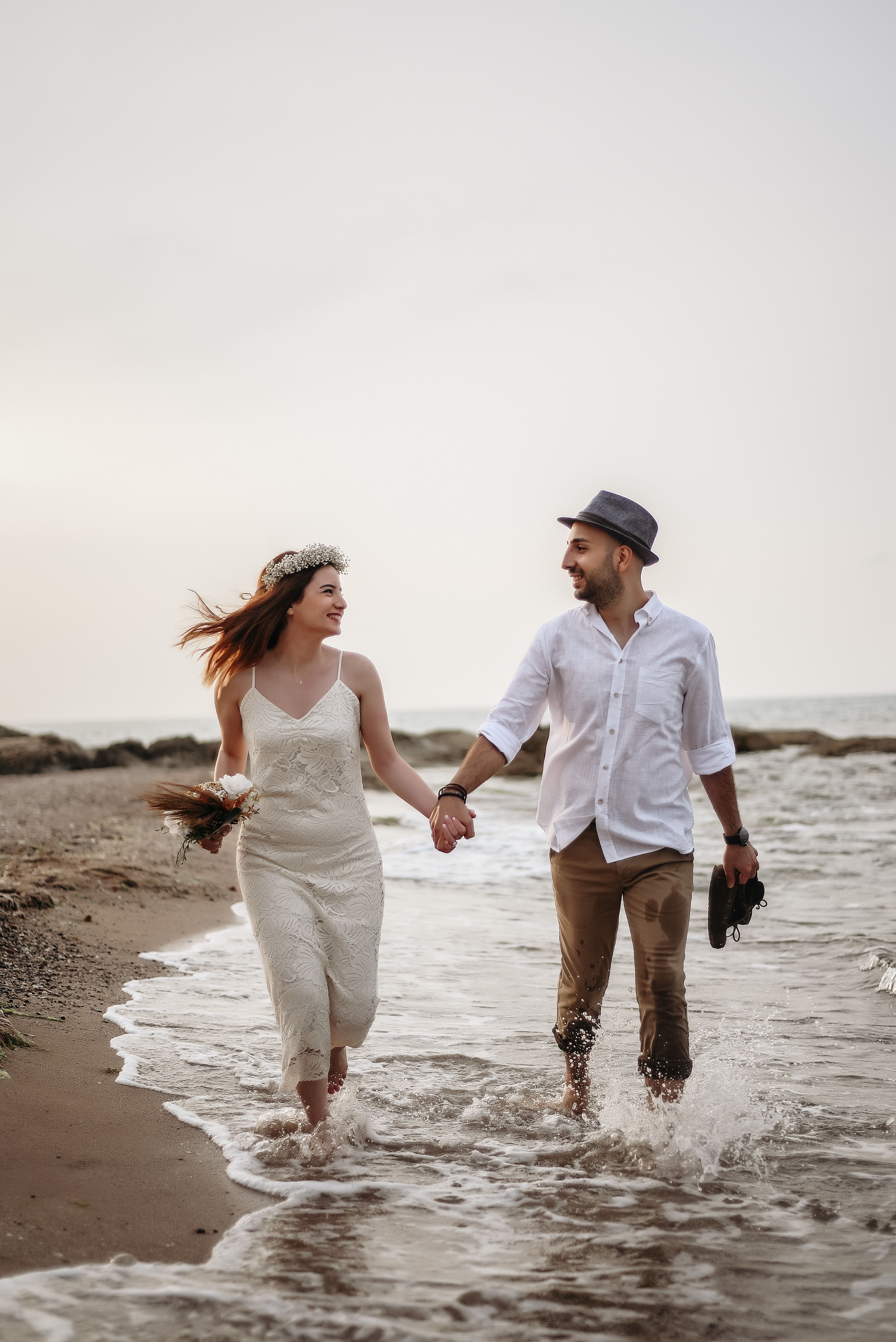 Happy couple walking on seaside · Free