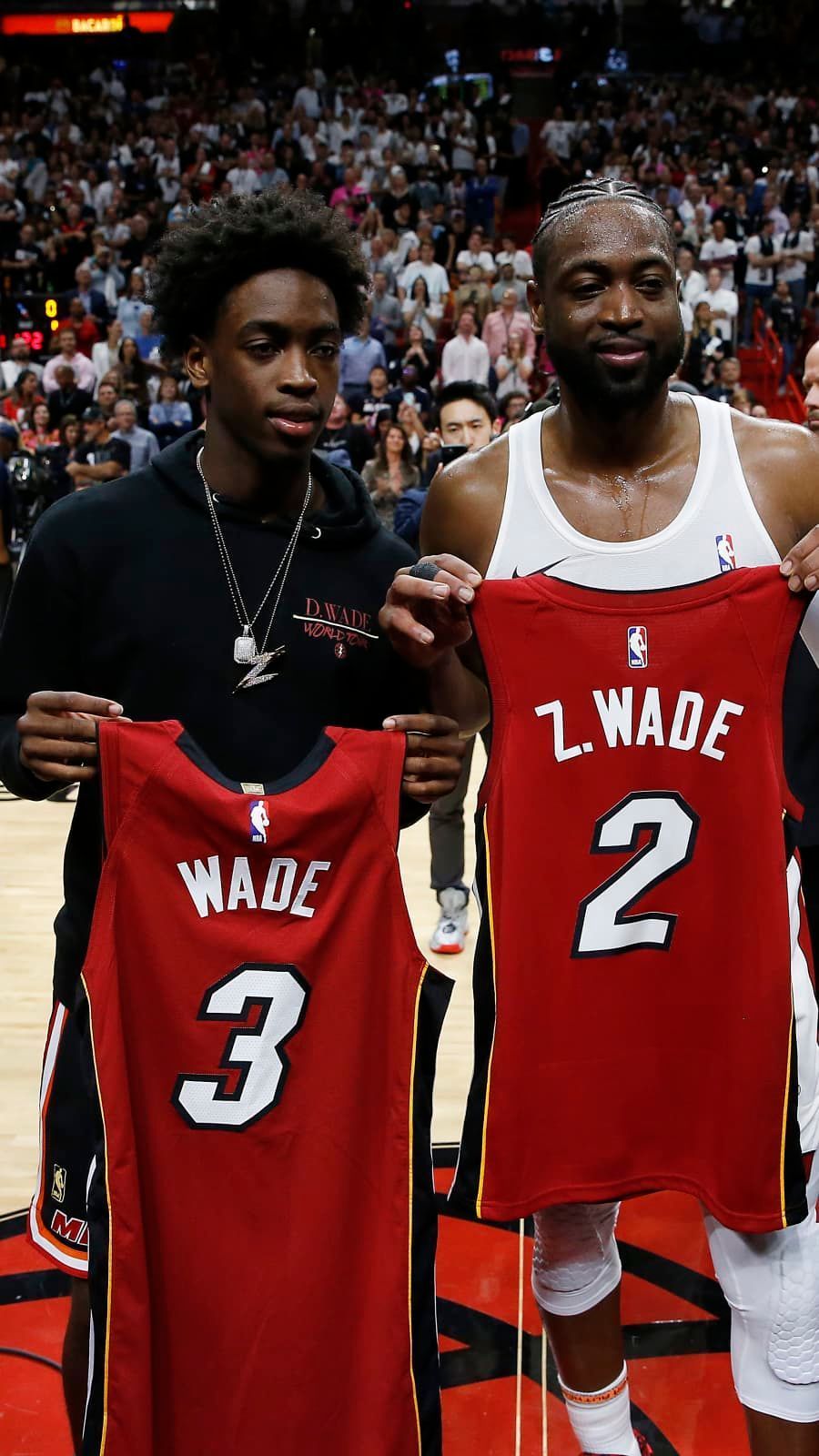 Dwyane Wade exchanges jerseys with his son, Zaire, after the final regular season home game of his career o. Dwyane wade, Basketball coach, Basketball players nba
