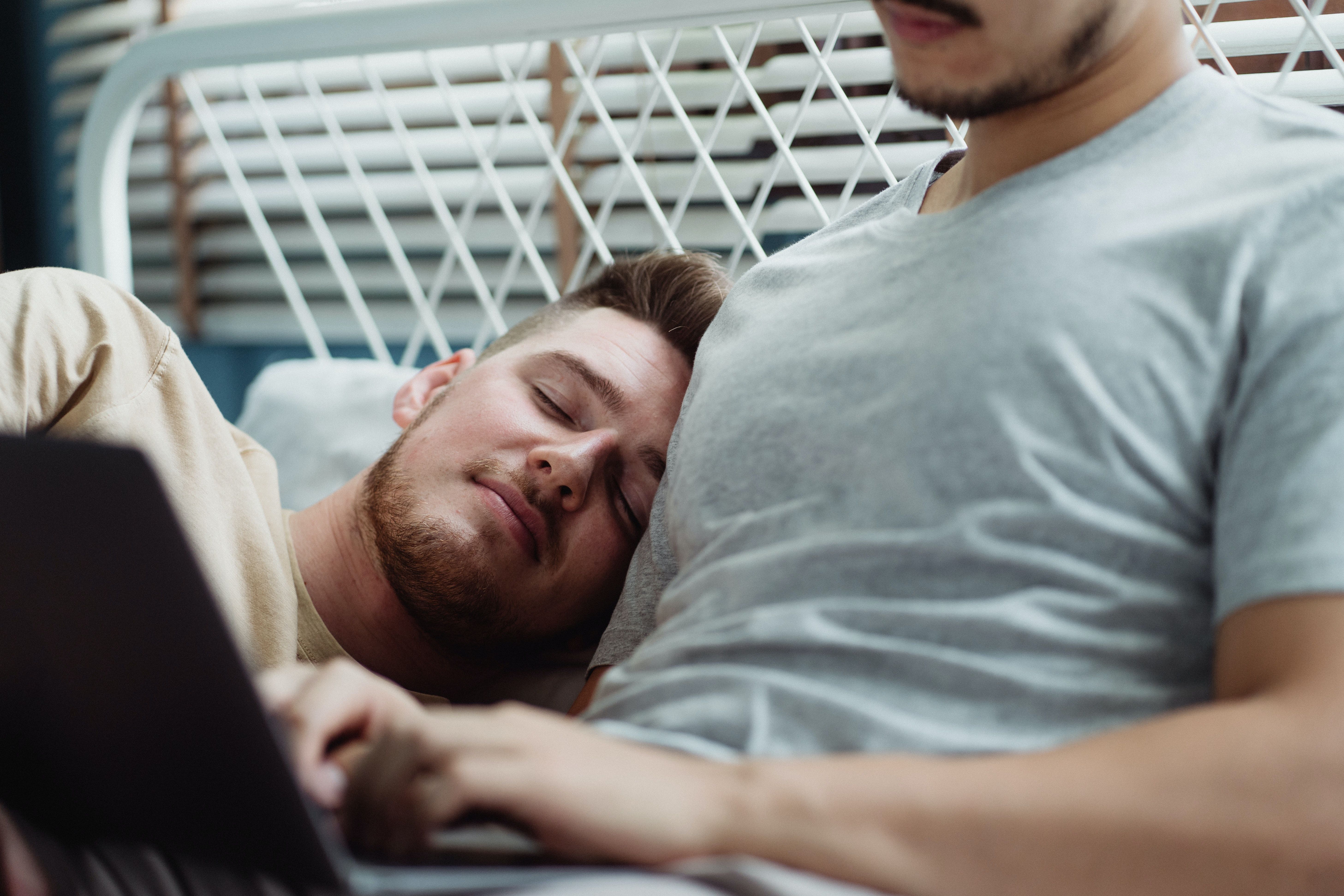 Sleeping Man Cuddling Against Another Man · Free