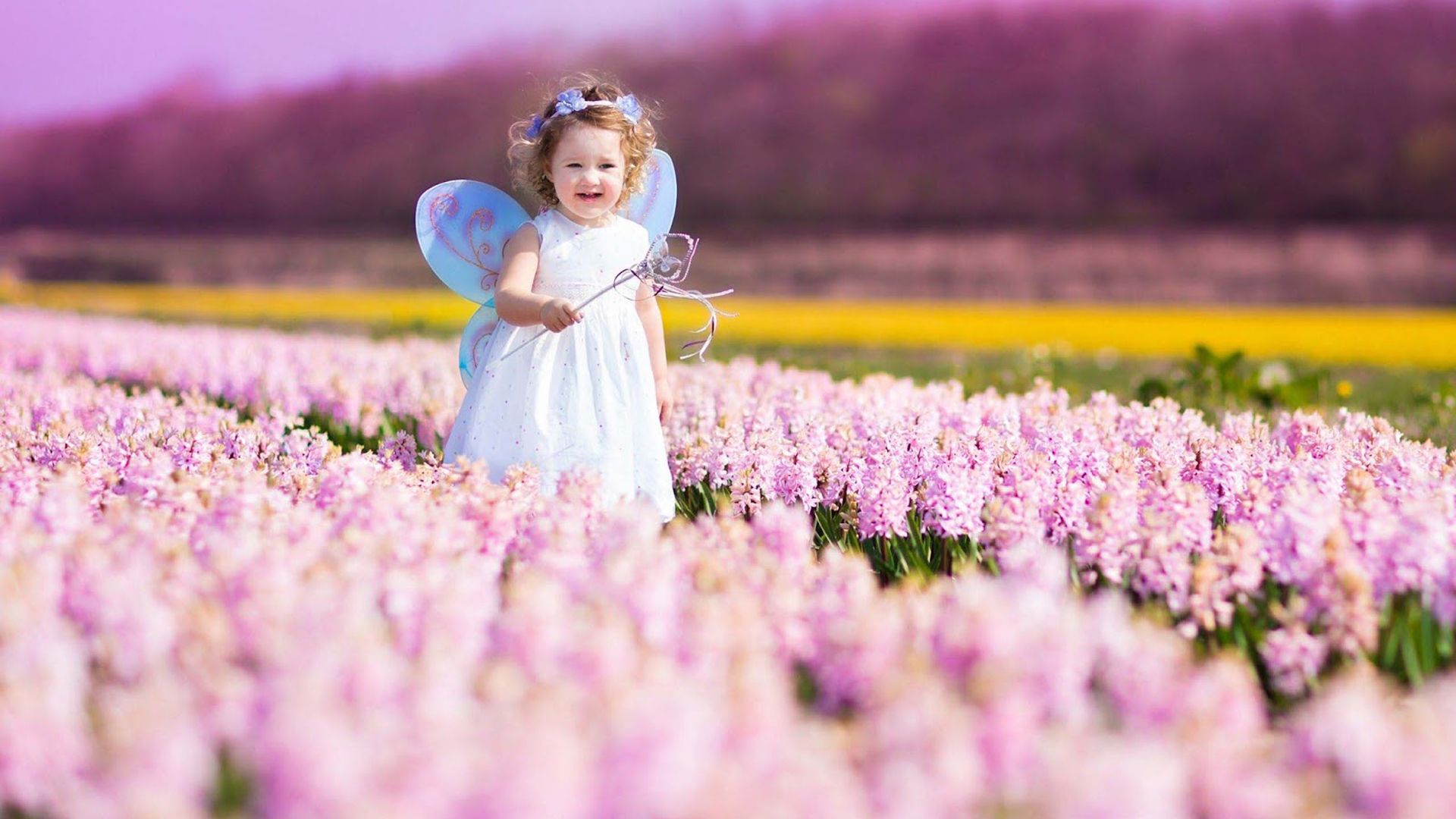 Cute Little Fairy Angel Girl Is Standing In The Middle Of Colorful Flowes Wearing White Dress In Blur Background HD Cute Wallpaper