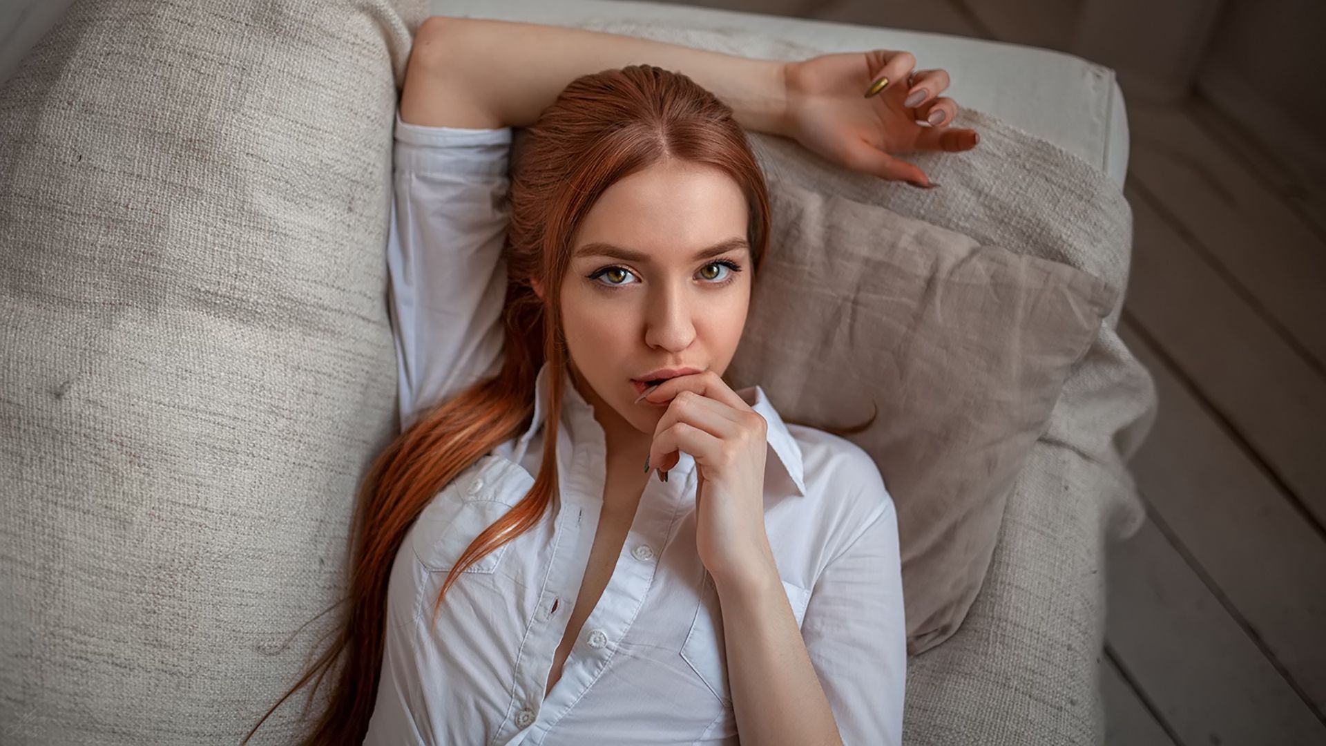 Wallpaper, women, face, portrait, redhead, white shirt, finger on lips, painted nails, long hair, couch, top view, looking at viewer 1920x1080