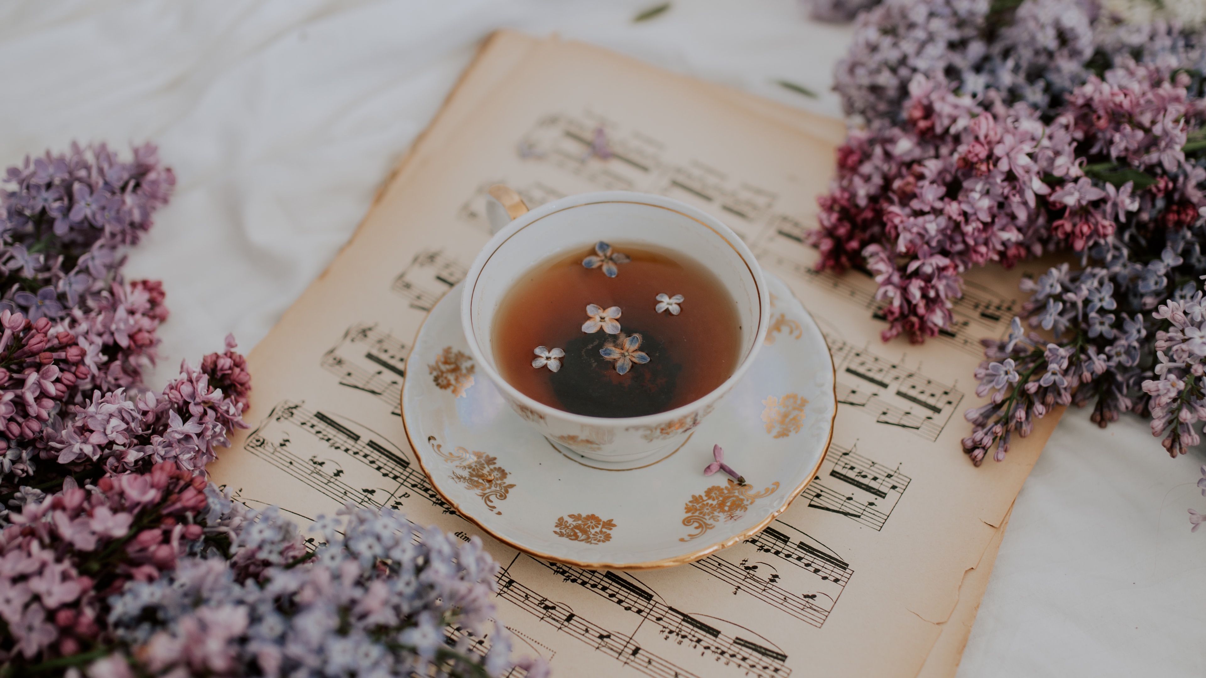 Download wallpaper 3840x2160 cup, tea, lilac, flowers, notes, still life 4k uhd 16:9 HD background