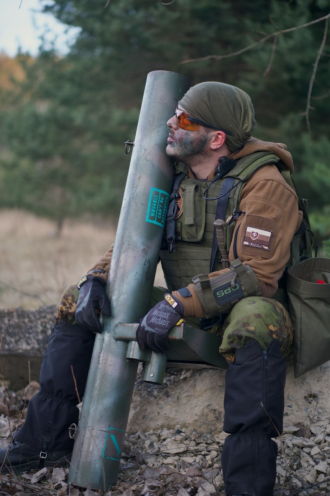 soldier man wearing tactical vest sitting while looking up photo
