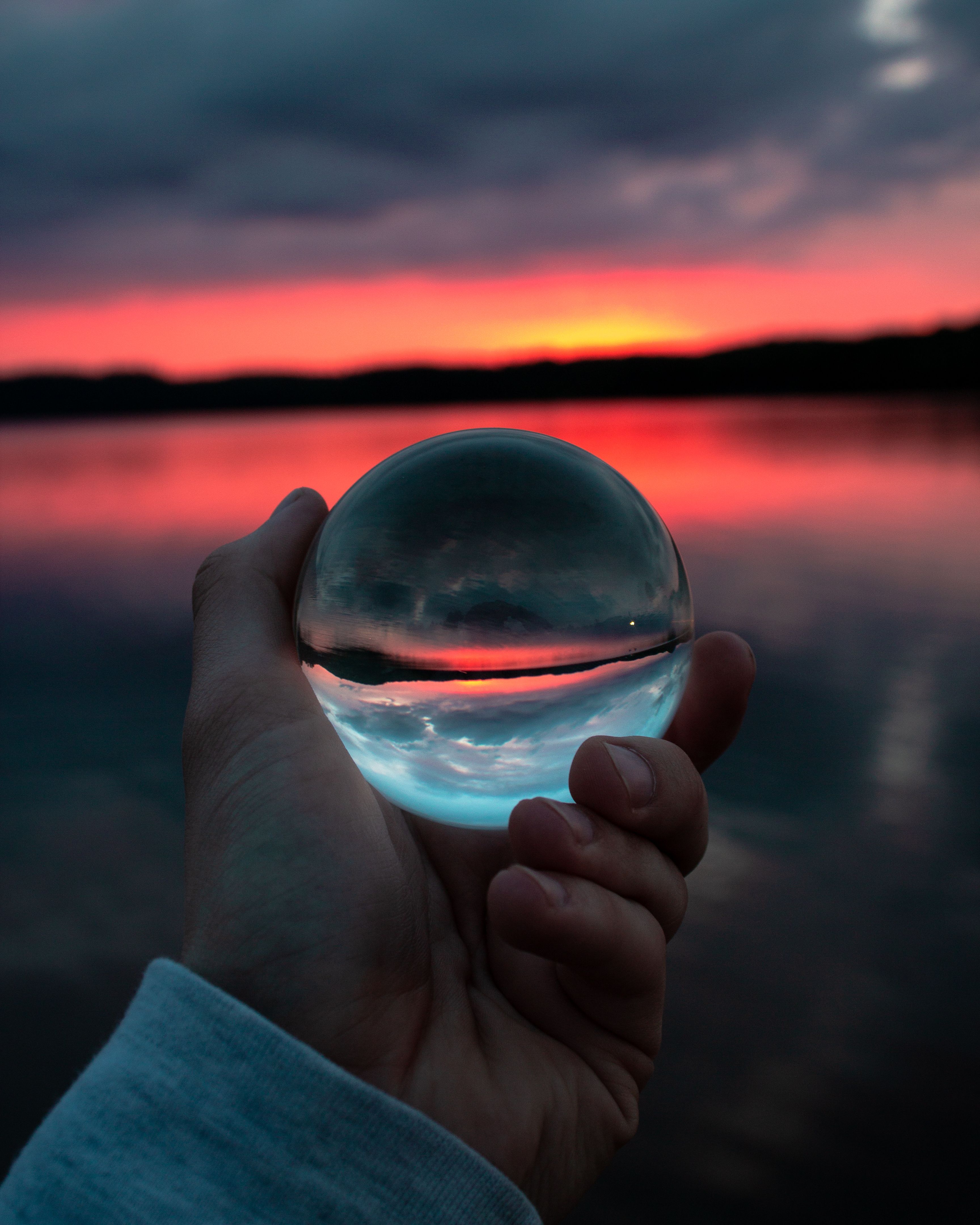 Person Holding Clear Glass Ball wallpaper