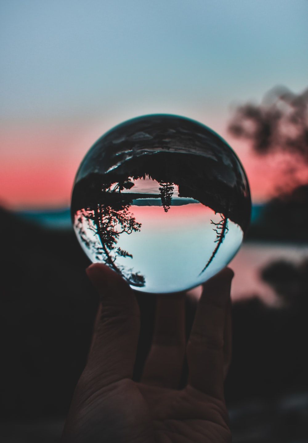 person holding clear crystal ball photo