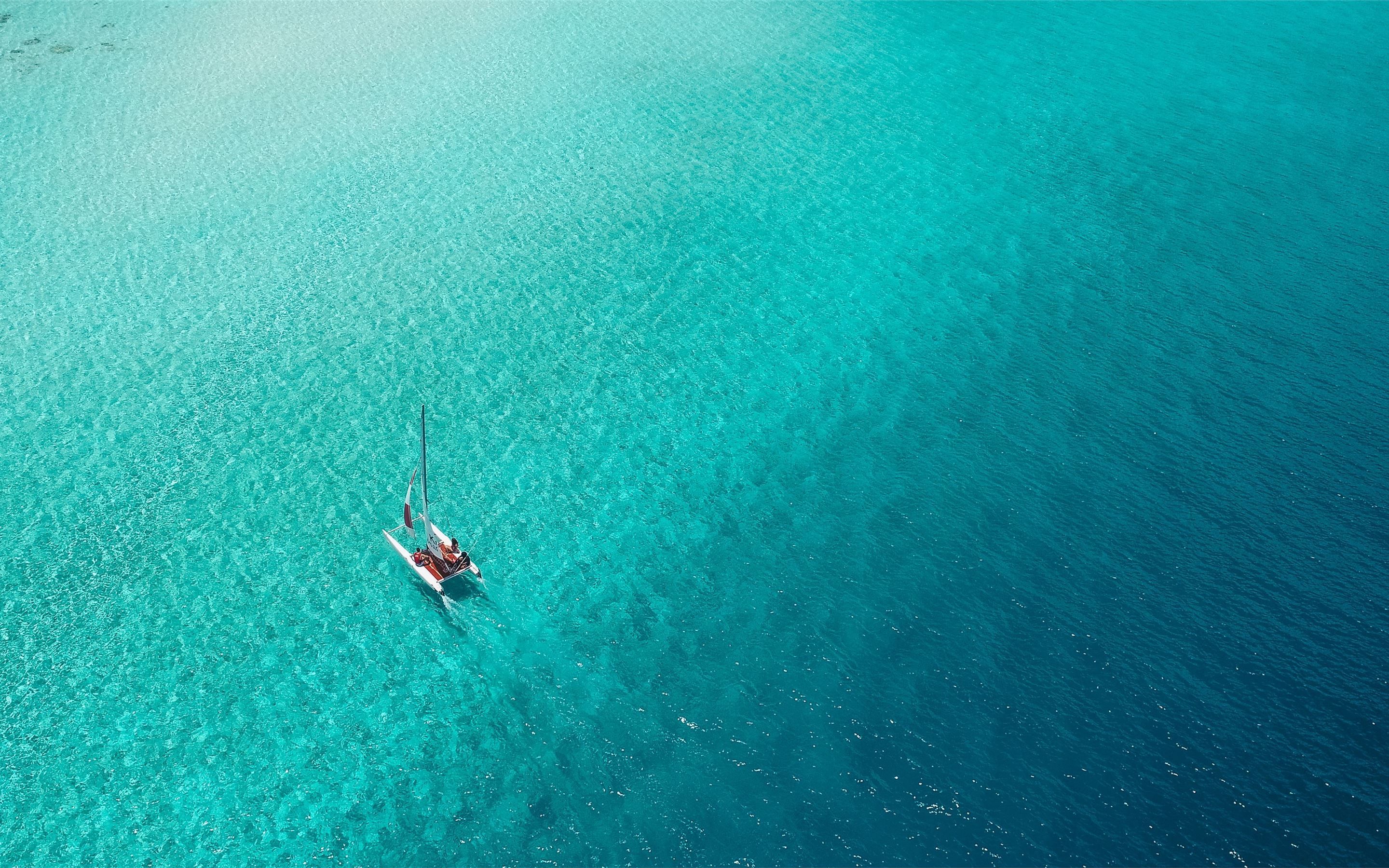 A catamaran sails across. MacBook Air Wallpaper Download