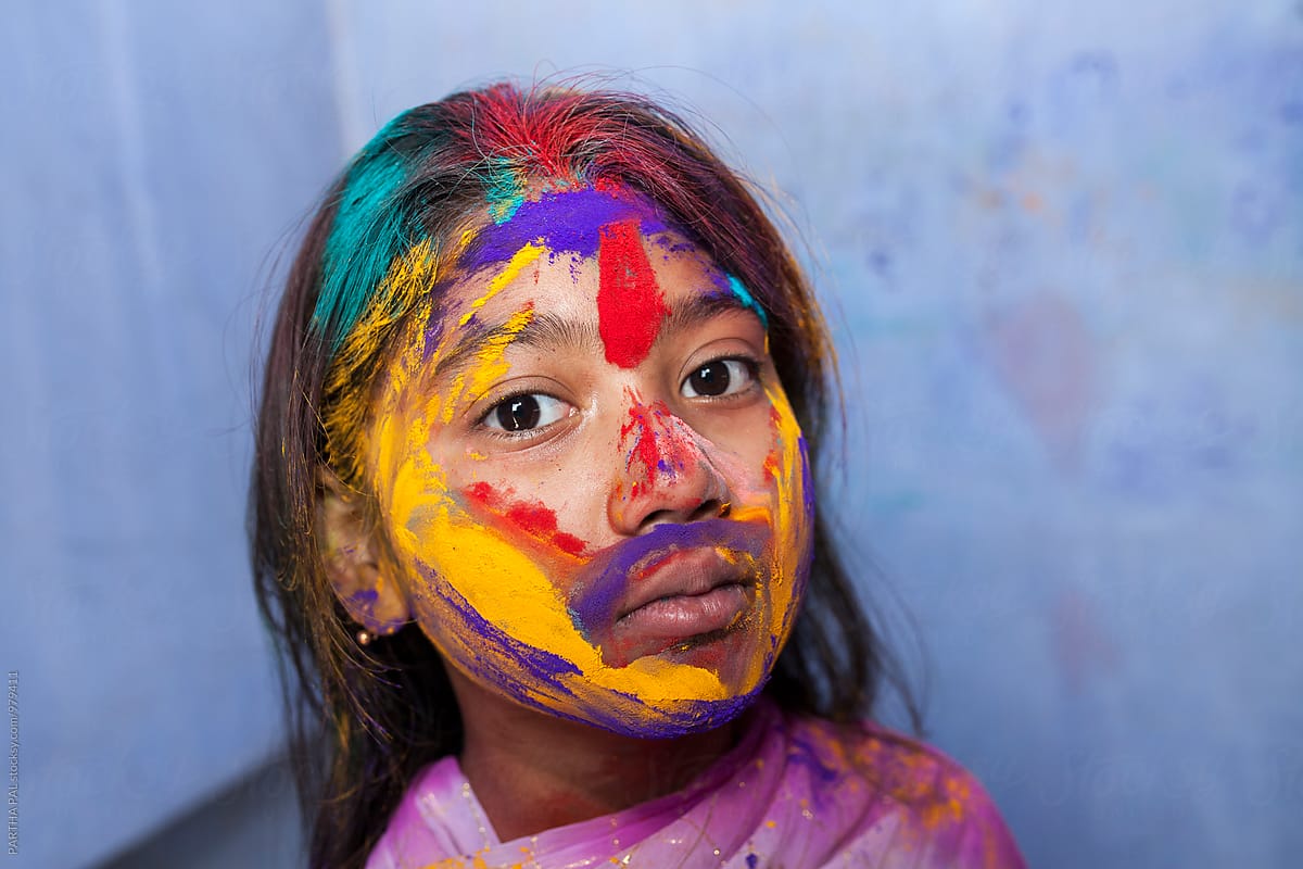 Indian Girl with colorful face in Holi festival