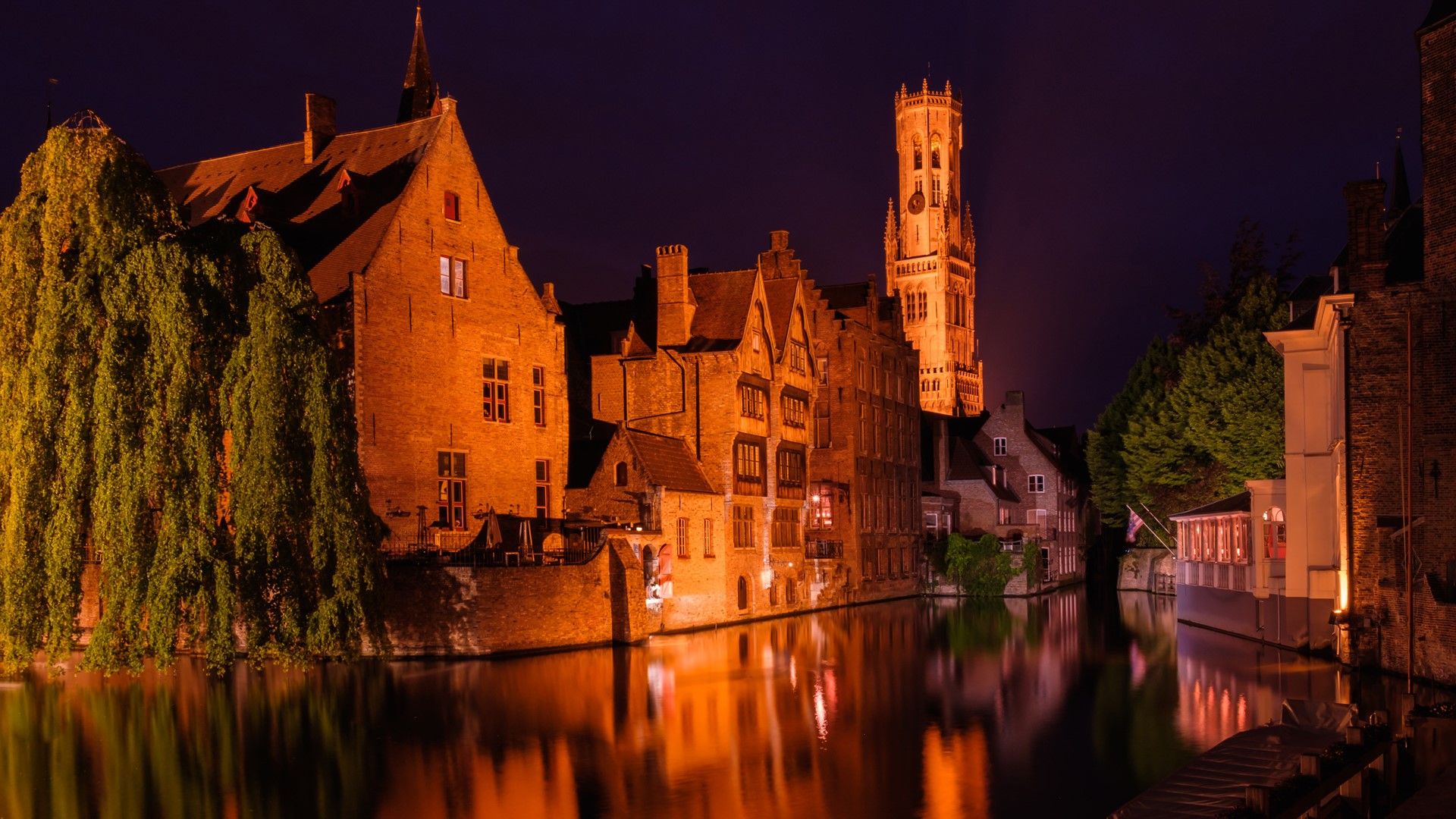 Huidenvetters plein, Dijver river canal and Belfort (Belfry) tower, Bruges, Belgium. Windows 10 Spotlight Image