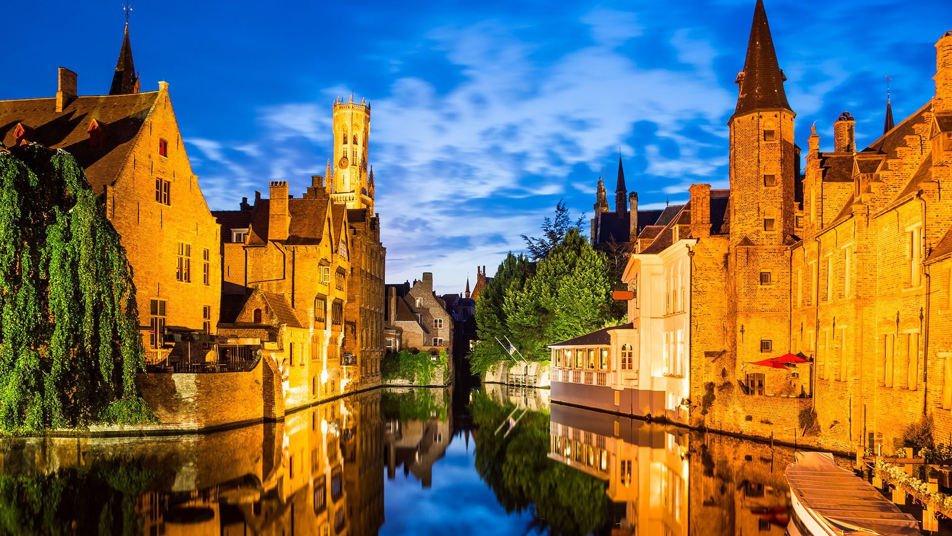 Rozenhoedkaai, Dijver river canal twilight and Belfort (Belfry) tower, Bruges, Belgium. Windows 10 Spotlight Image