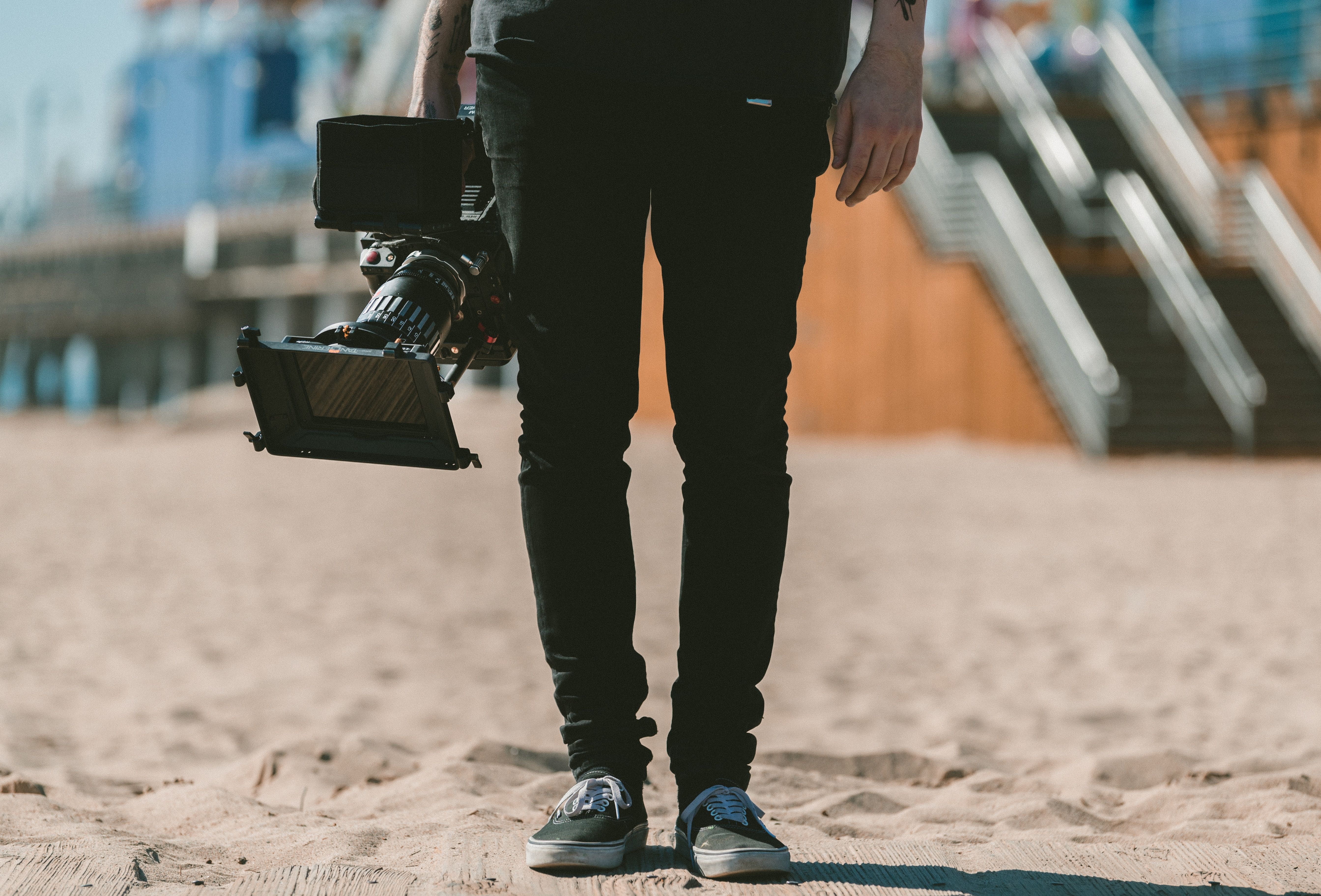 5376x3648 #Free image, #outdoor, #man, #videography, #shoe, #video camera, #caucasian, #video, #film camera, #hold, #equipment, #person, #guy, #holding, #leg, #photo, #camera, #sand, #beach, #male, #tattoo