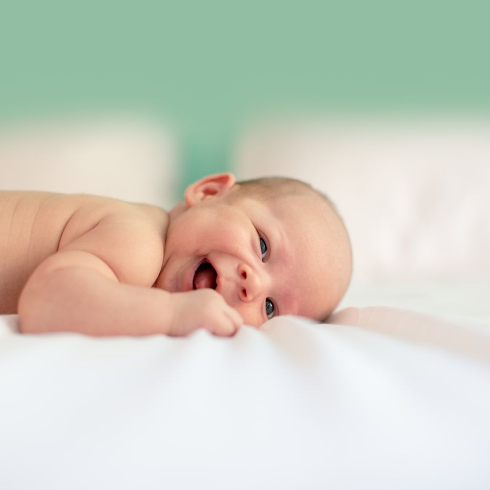 baby lying on fabric cloth photo