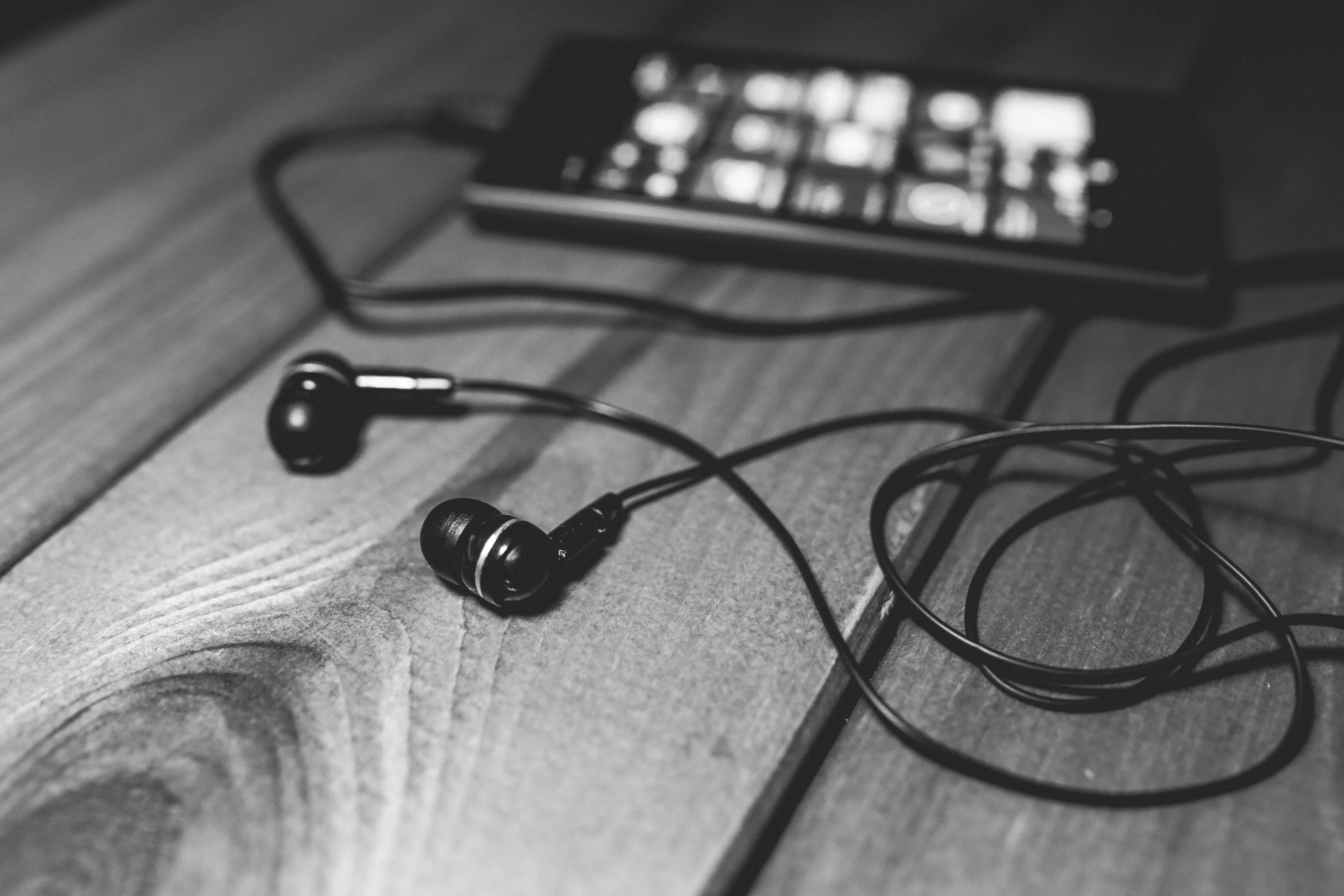 Black earphones on a desk · Free