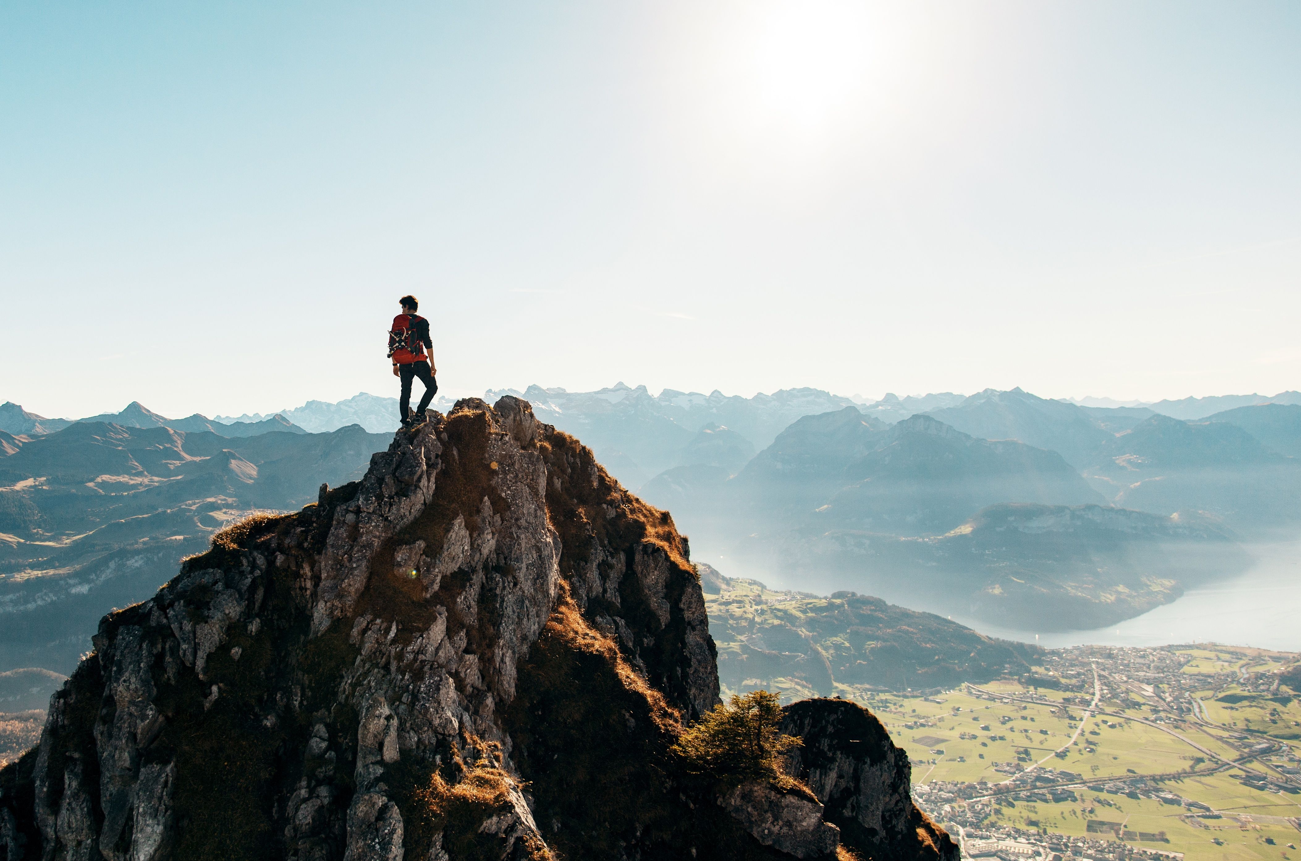 Hiker on top of a mountain 4K UHD Wallpaper