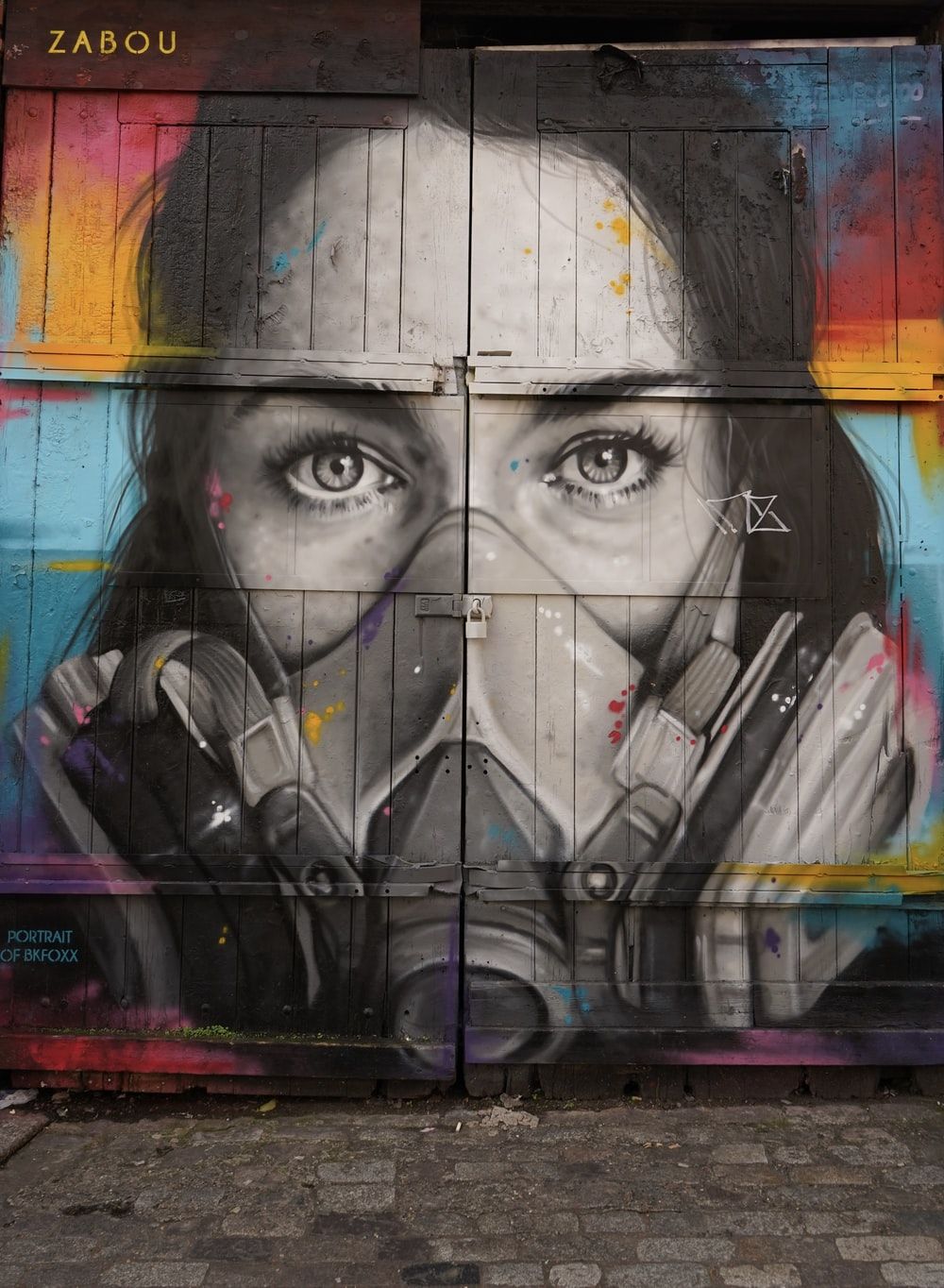 woman wearing oxygen mask graffiti on plank wall photo