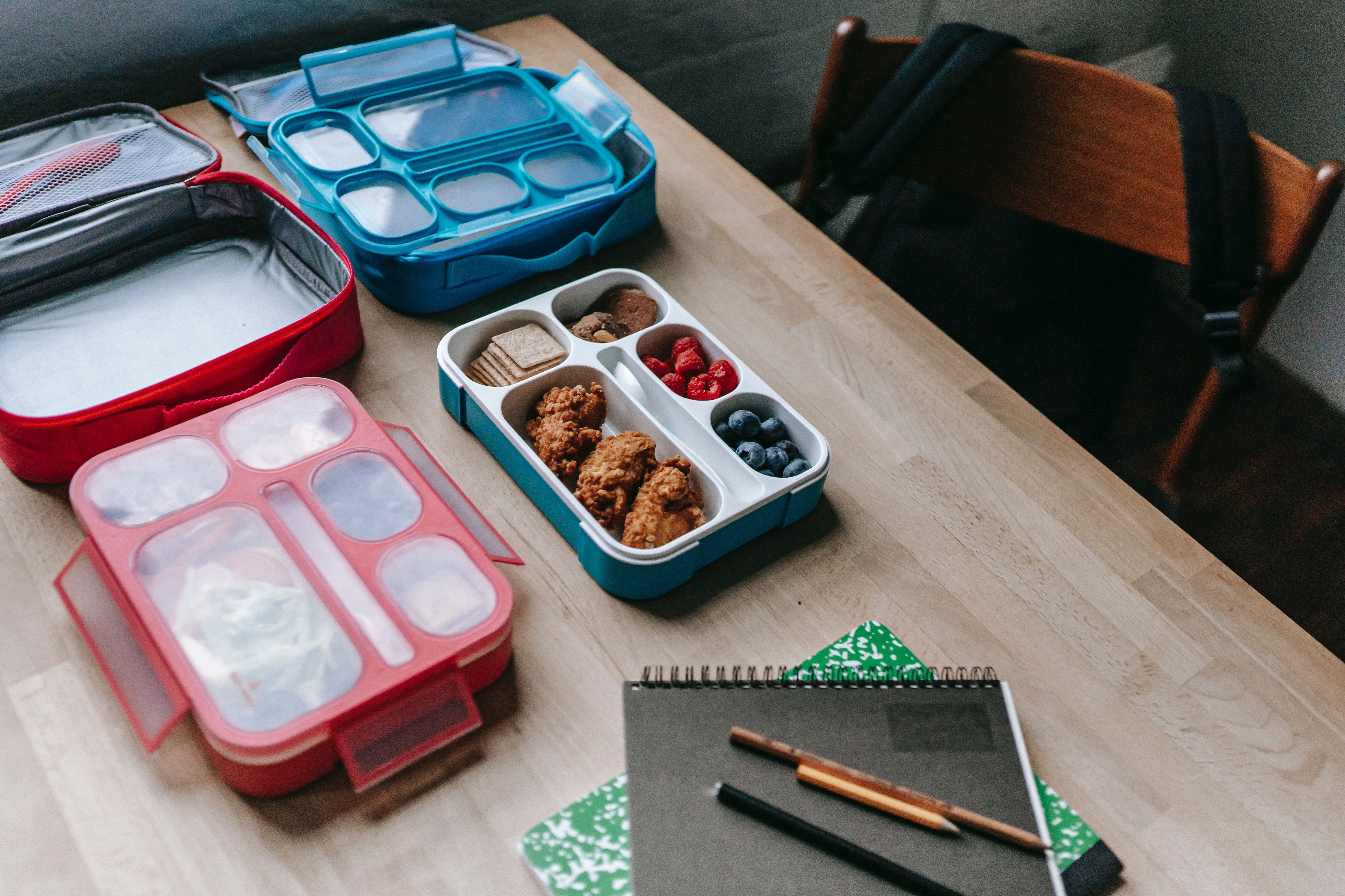 Lunch boxes with delicious food in classroom · Free