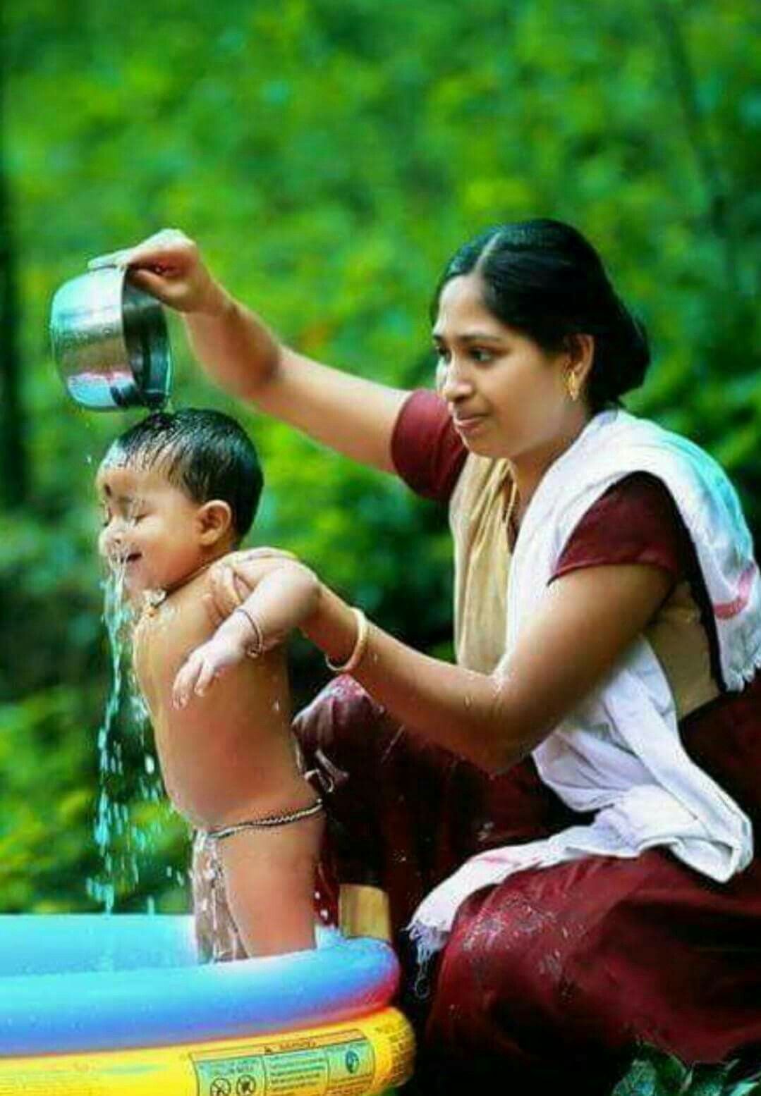 Kerala Woman bathing the child. Mother in the private sphere taking care of the child. Mother baby photography, Village photography, Baby art picture