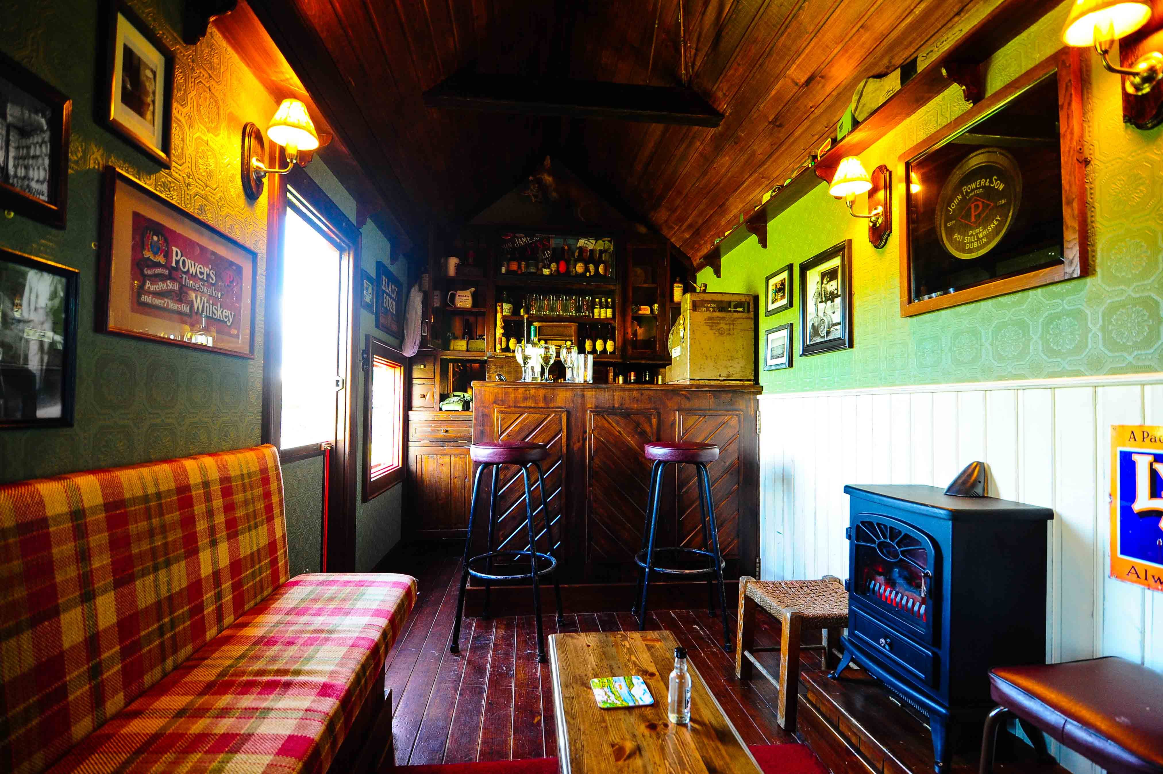 The Shebeen Mobile Irish Pub. Fully functioning bar, seating for 10 & sound system. Green walls. White paneling. Bar stools. Plaid. Pub sheds, Irish pub, Home pub