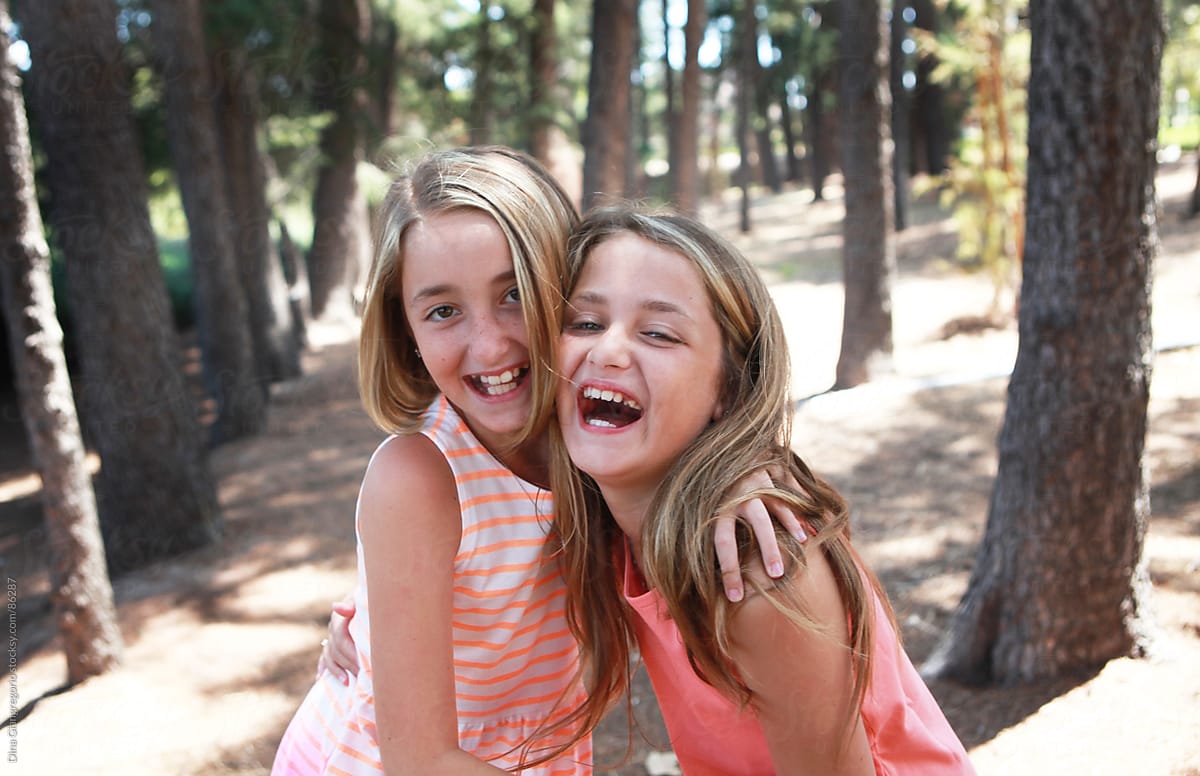 Two Young Girls Laughing In Park by Dina Marie Giangregorio
