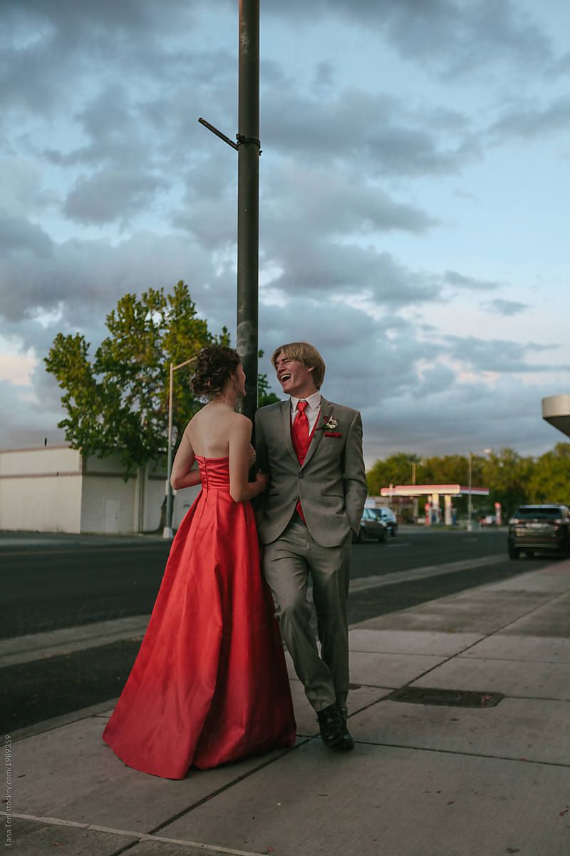 teenage couple dressed up for high school prom having fun before the dance