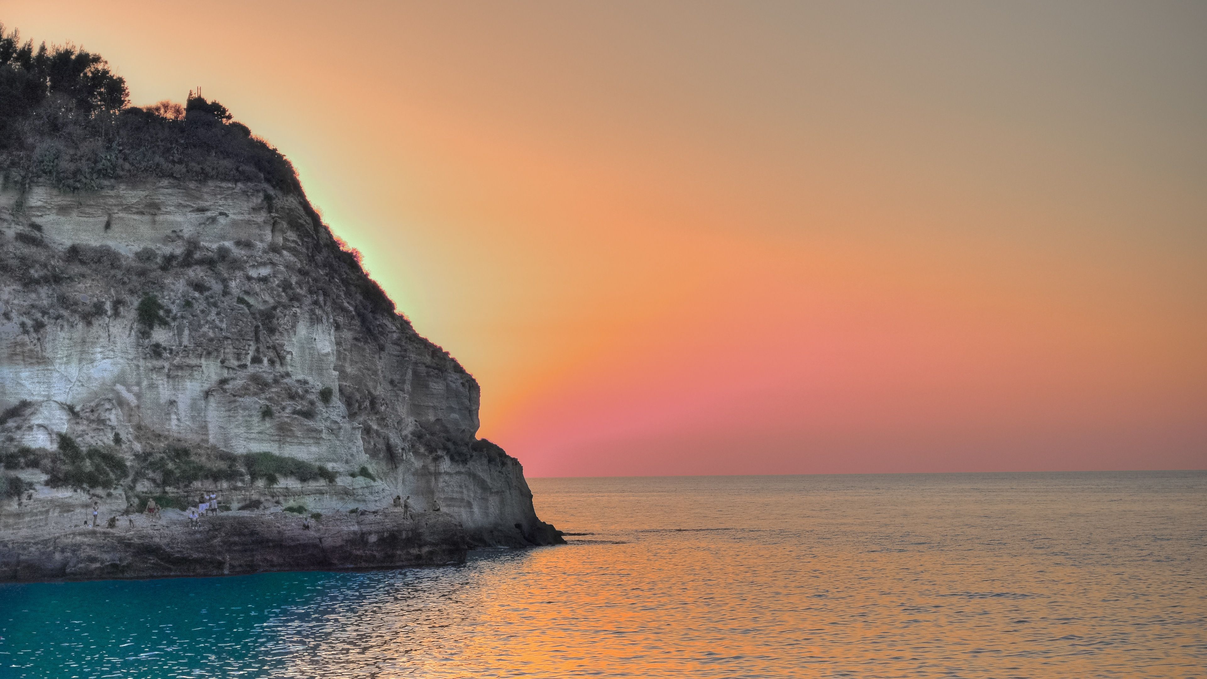 Ocean Sun Setting Behind Cliff 4K Ultra HD Desktop Wallpaper