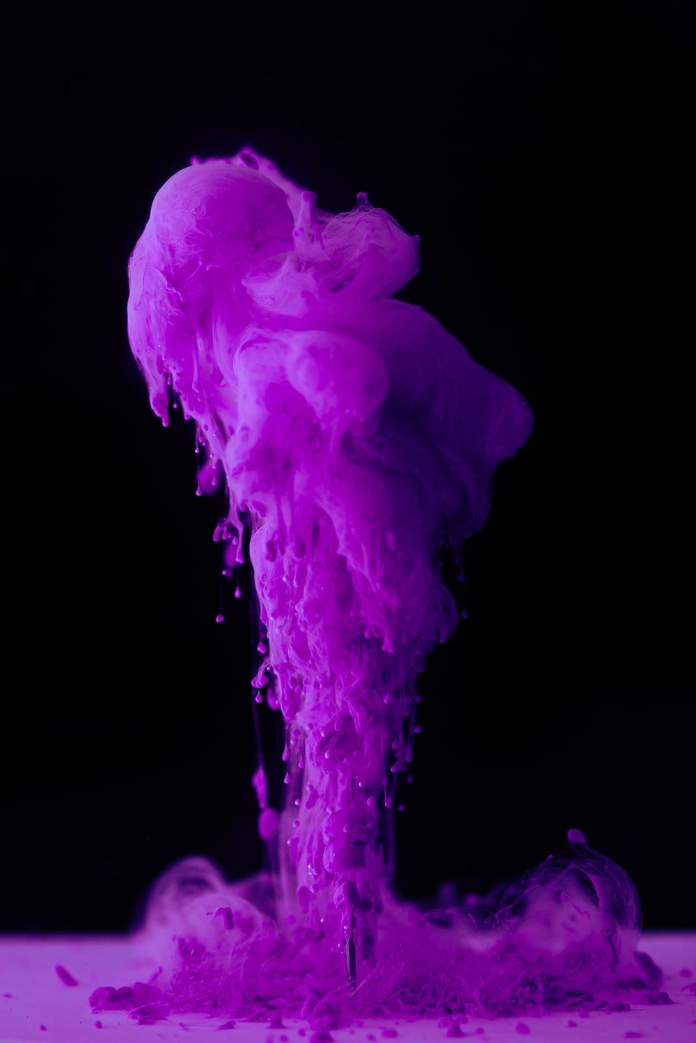 purple smoke on black background photo