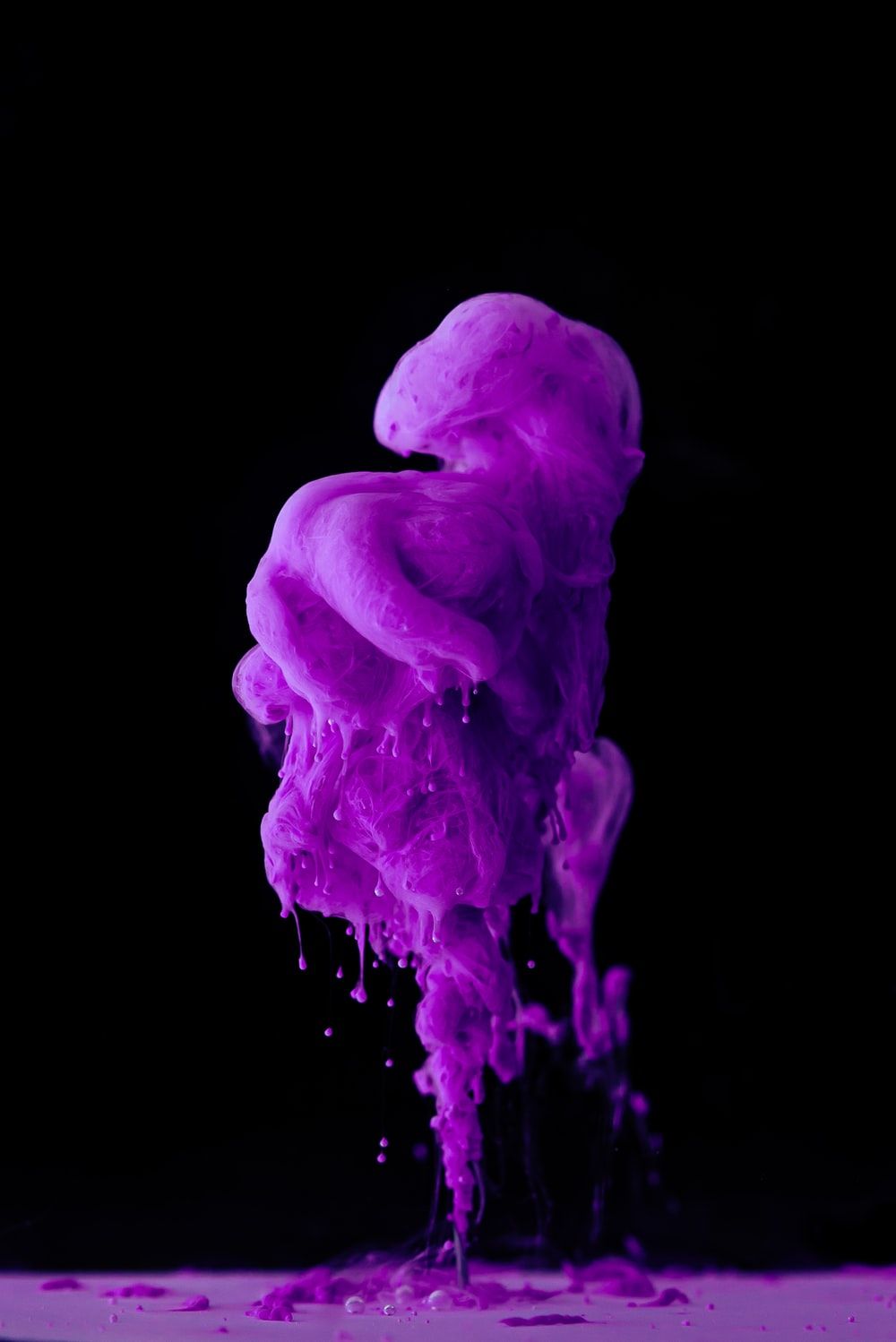 purple smoke on black background photo
