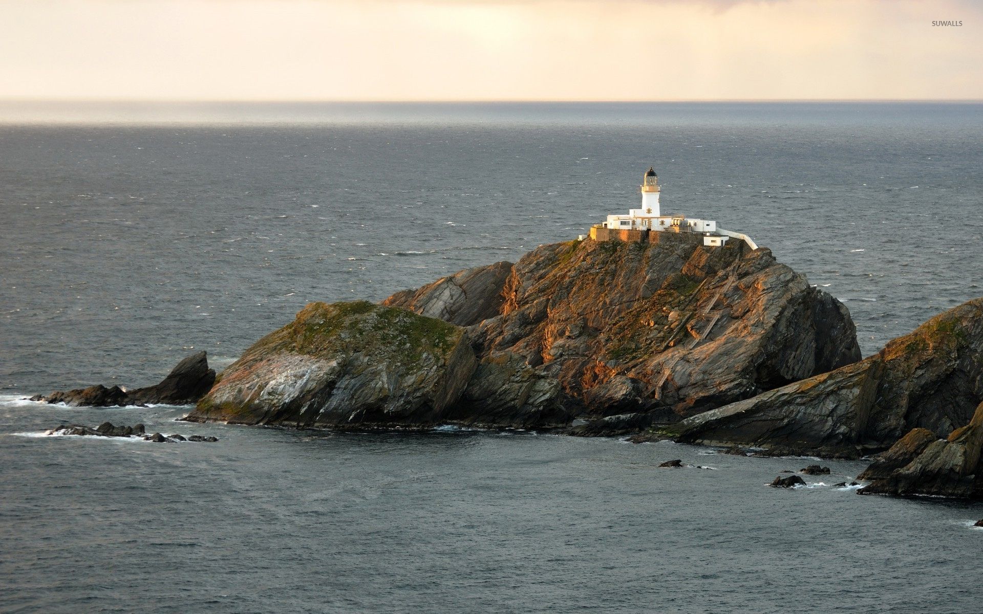 Lighthouse on a rocky cliff wallpaper wallpaper