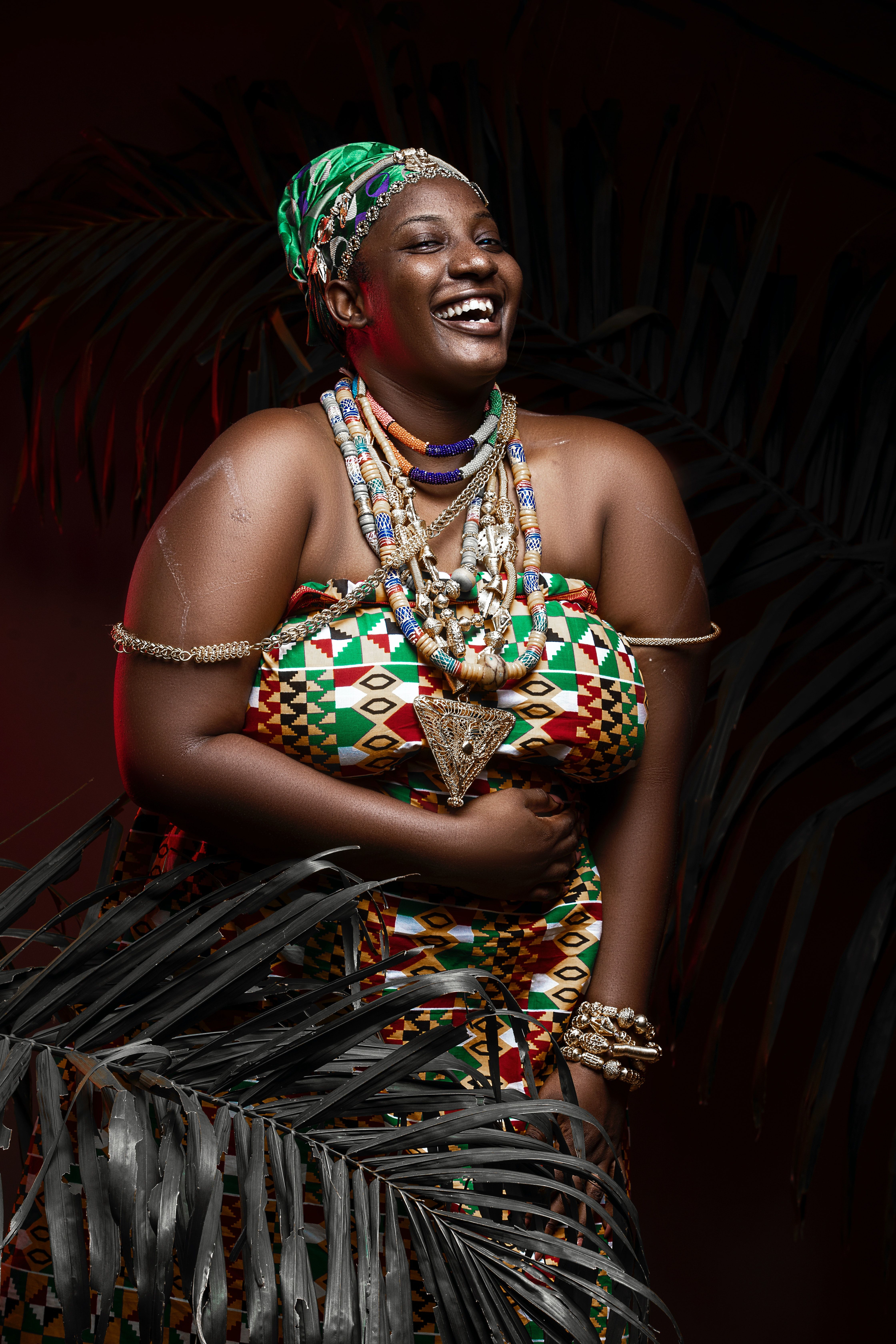 Smiling black woman in traditional outfit and accessories · Free