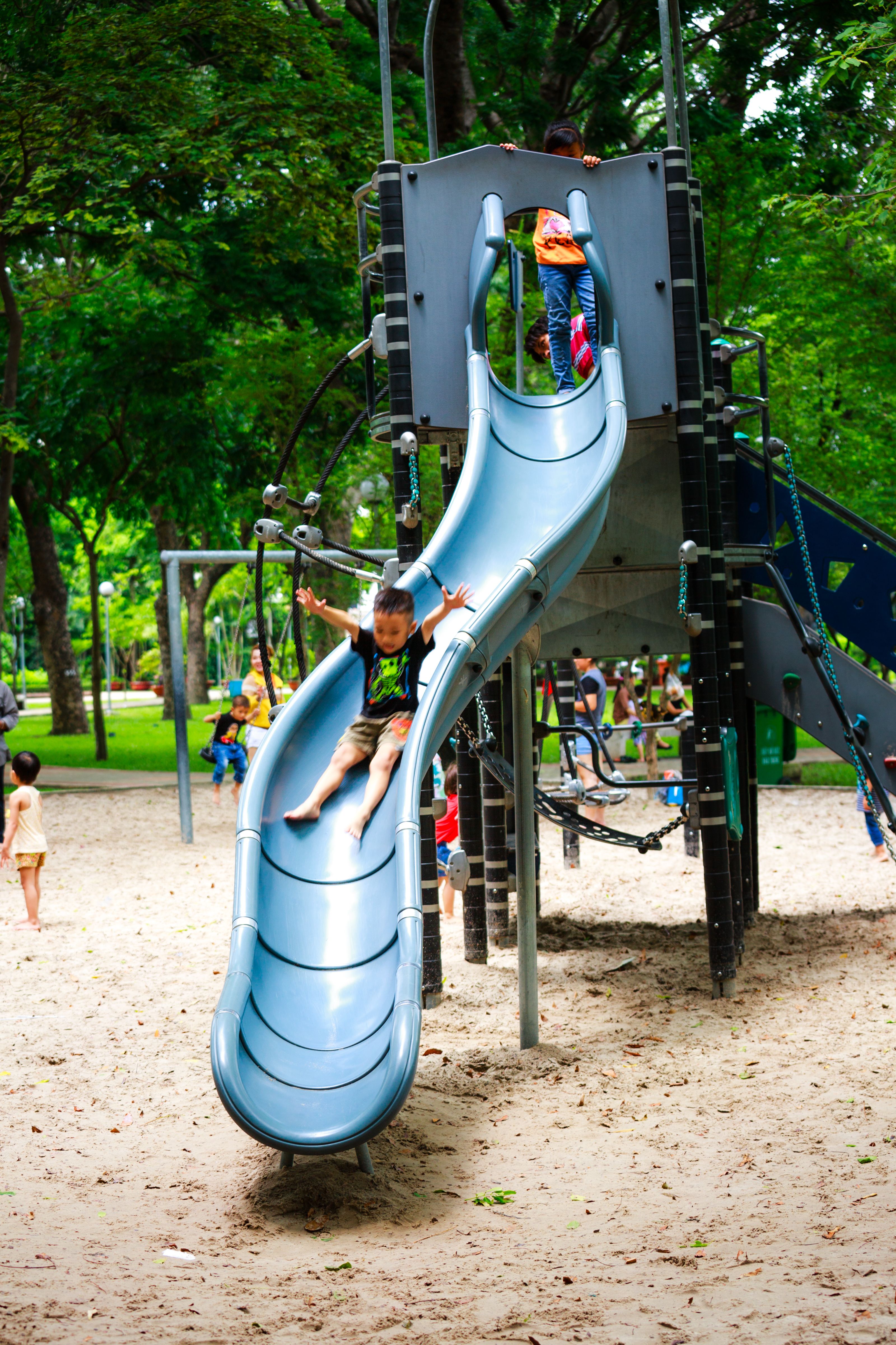 Boy Playing on Slide in Playground · Free