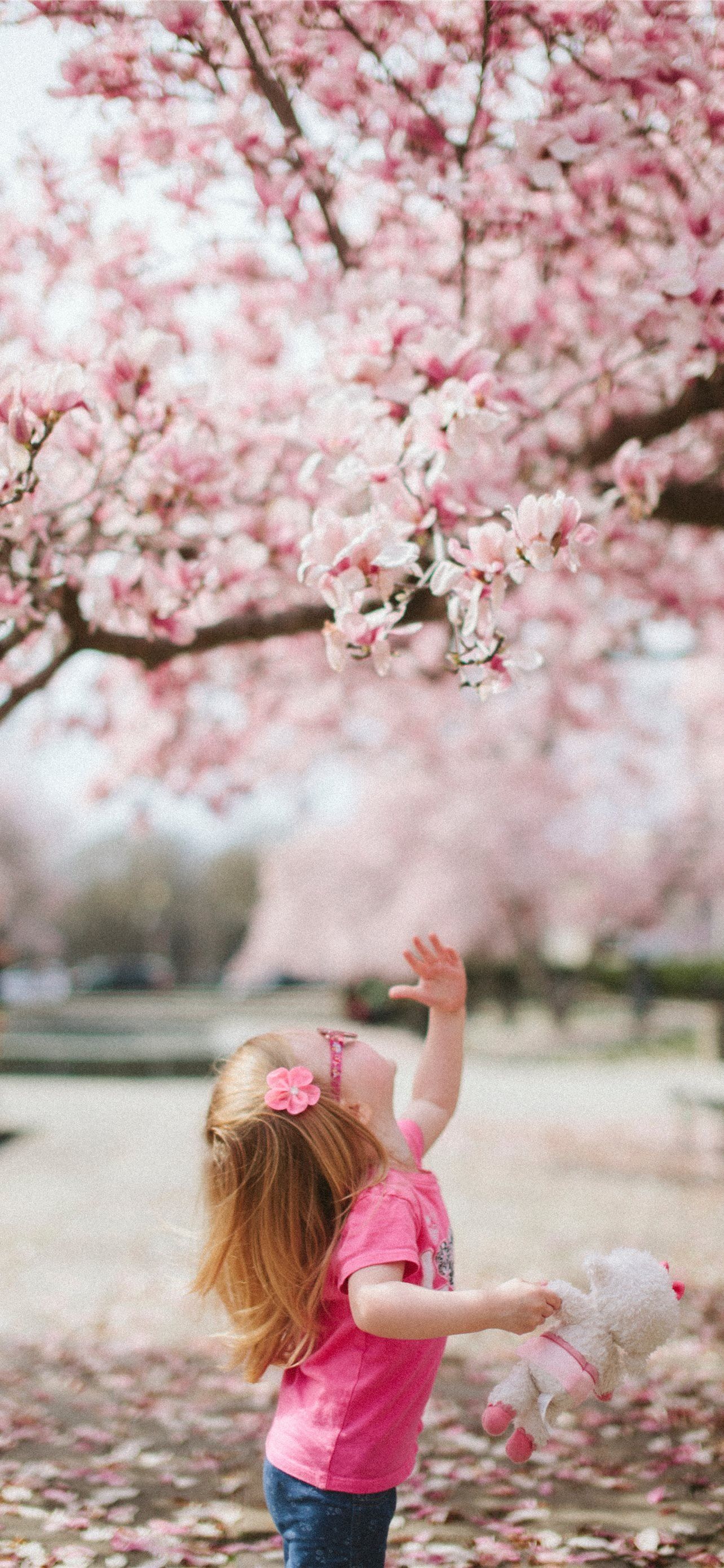girl under cherry blossom tree iPhone 12 Wallpaper Free Download