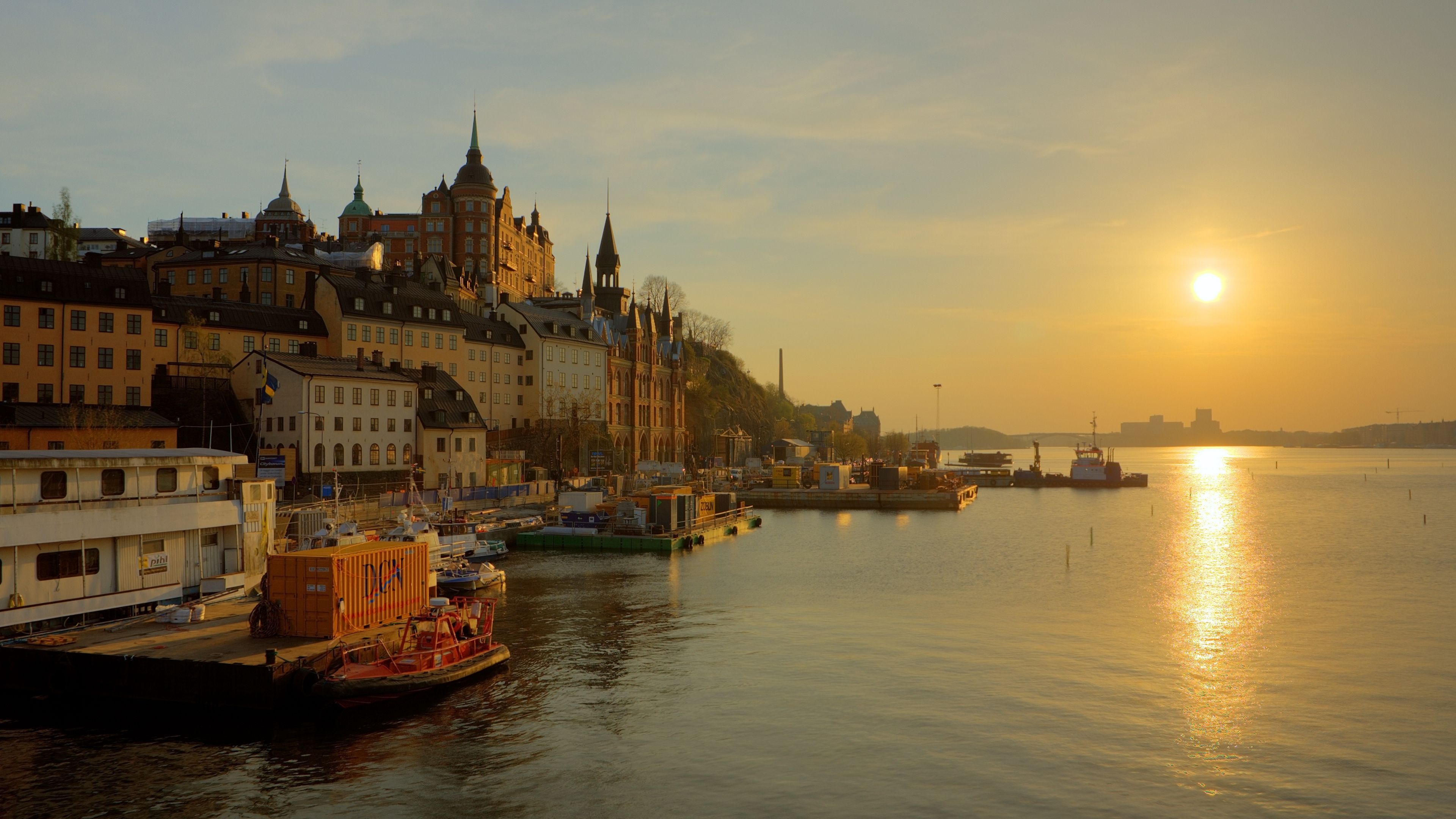 Wallpaper 4k sweden, stockholm, promenade, river, sun, track, sunrise, fog, gold, houses, towers, water, boat, reflection, sky 4k promenade, Stockholm, sweden