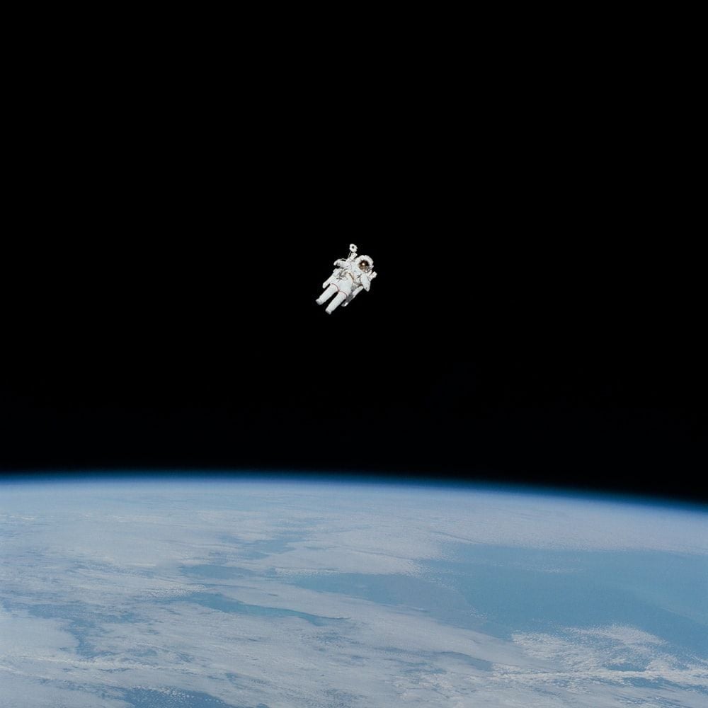 astronaut in spacesuit floating in space photo