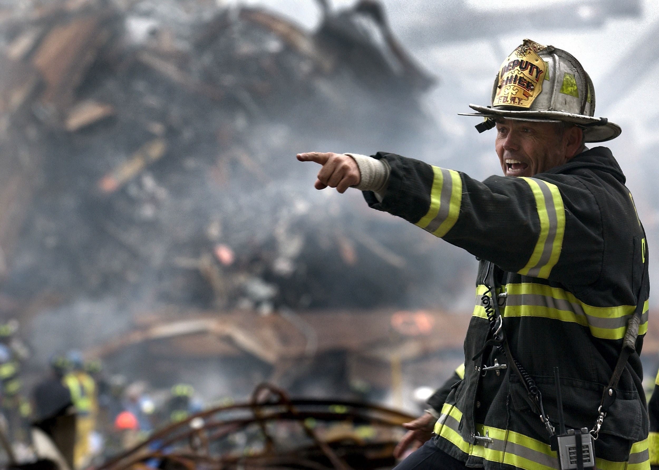 Fire Fighter Wearing Black and Yellow Uniform Pointing for Something · Free