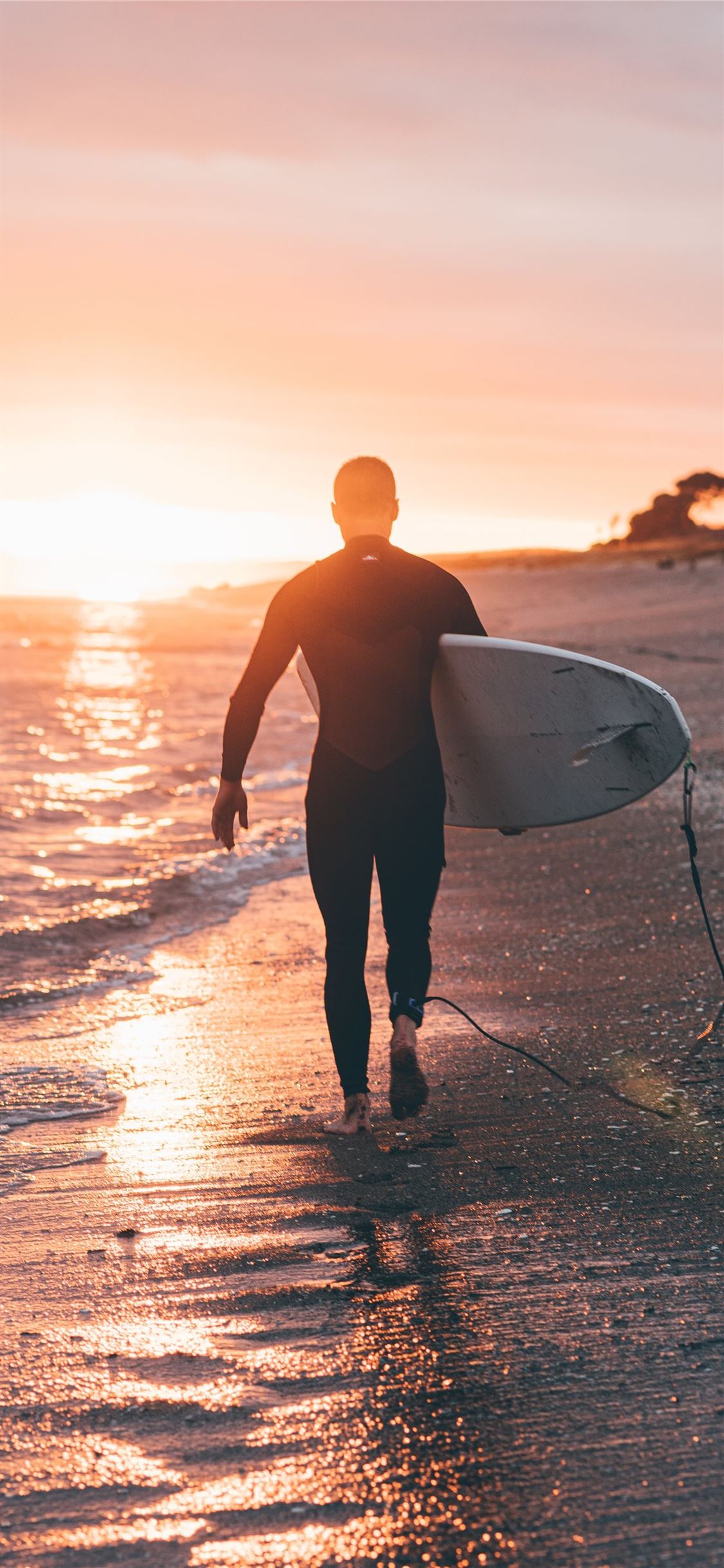 man holding white surfboard iPhone X Wallpaper Free Download
