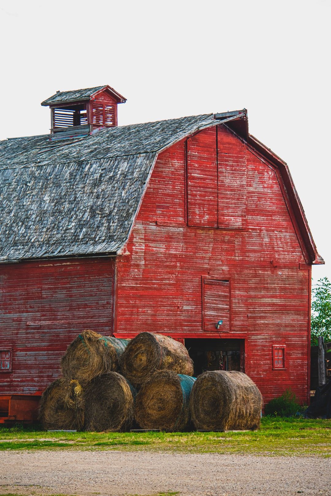 barn beside hay rolls photo